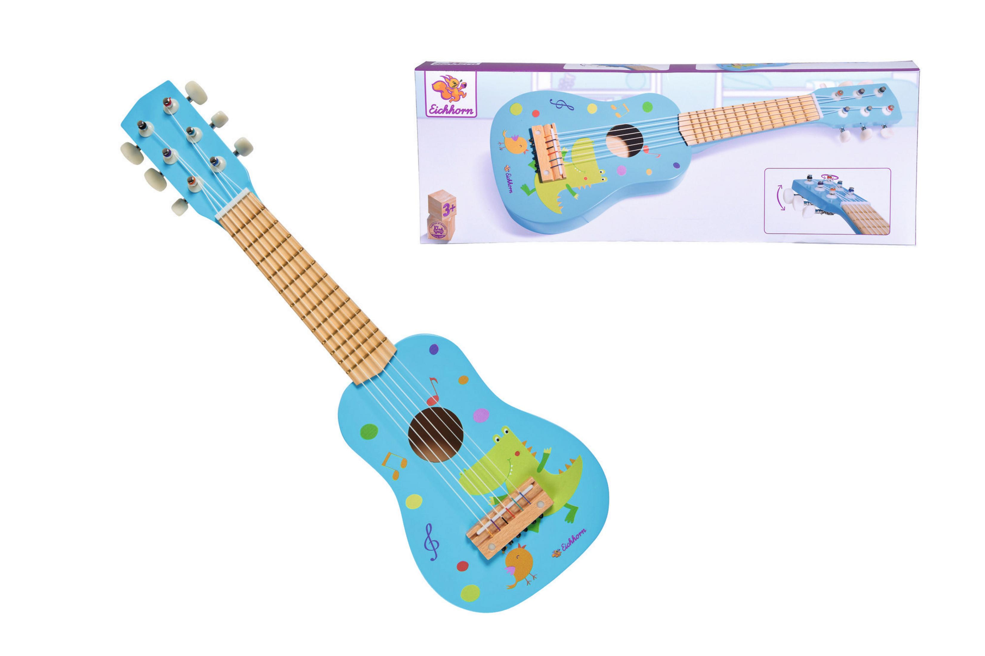 Eine blaue Spielzeug-Gitarre mit bunten Verzierungen von Zeichentieren. Eine Box ist auch abgebildet.