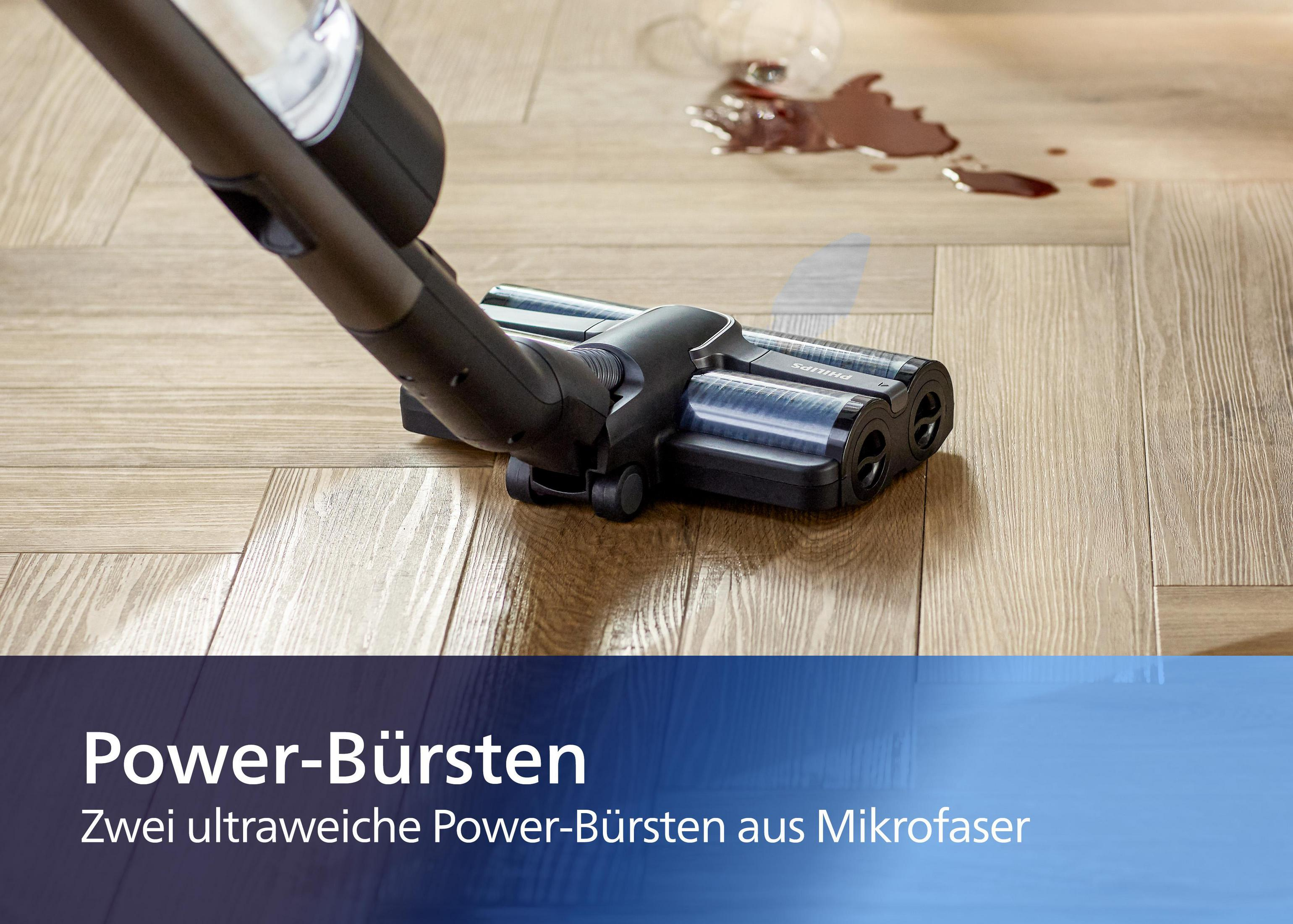 Ein Staubsaugerkopf auf Holzboden. Text: 'Power-Bürsten'.