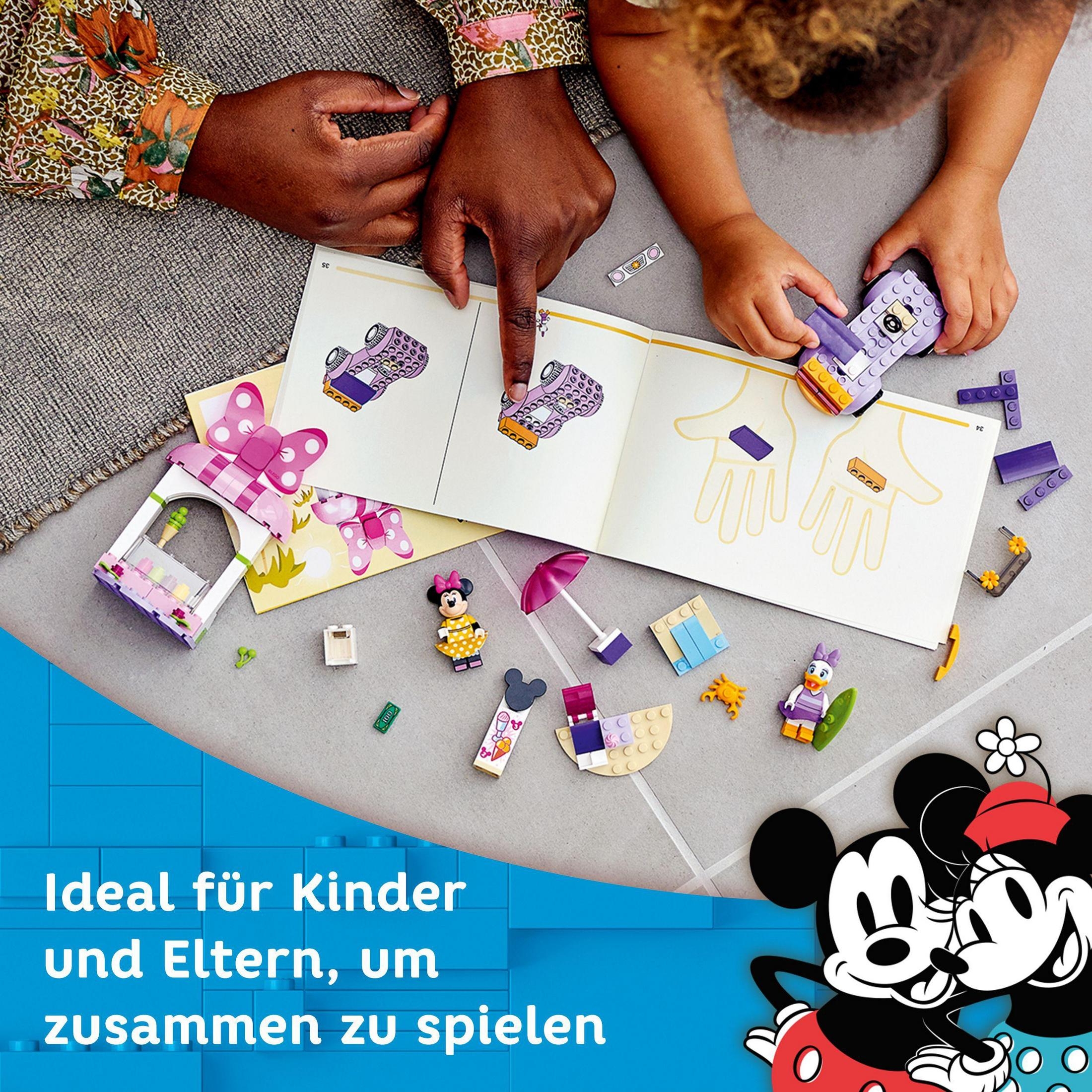Children building with Lego bricks, with instruction manual and Mickey Mouse.