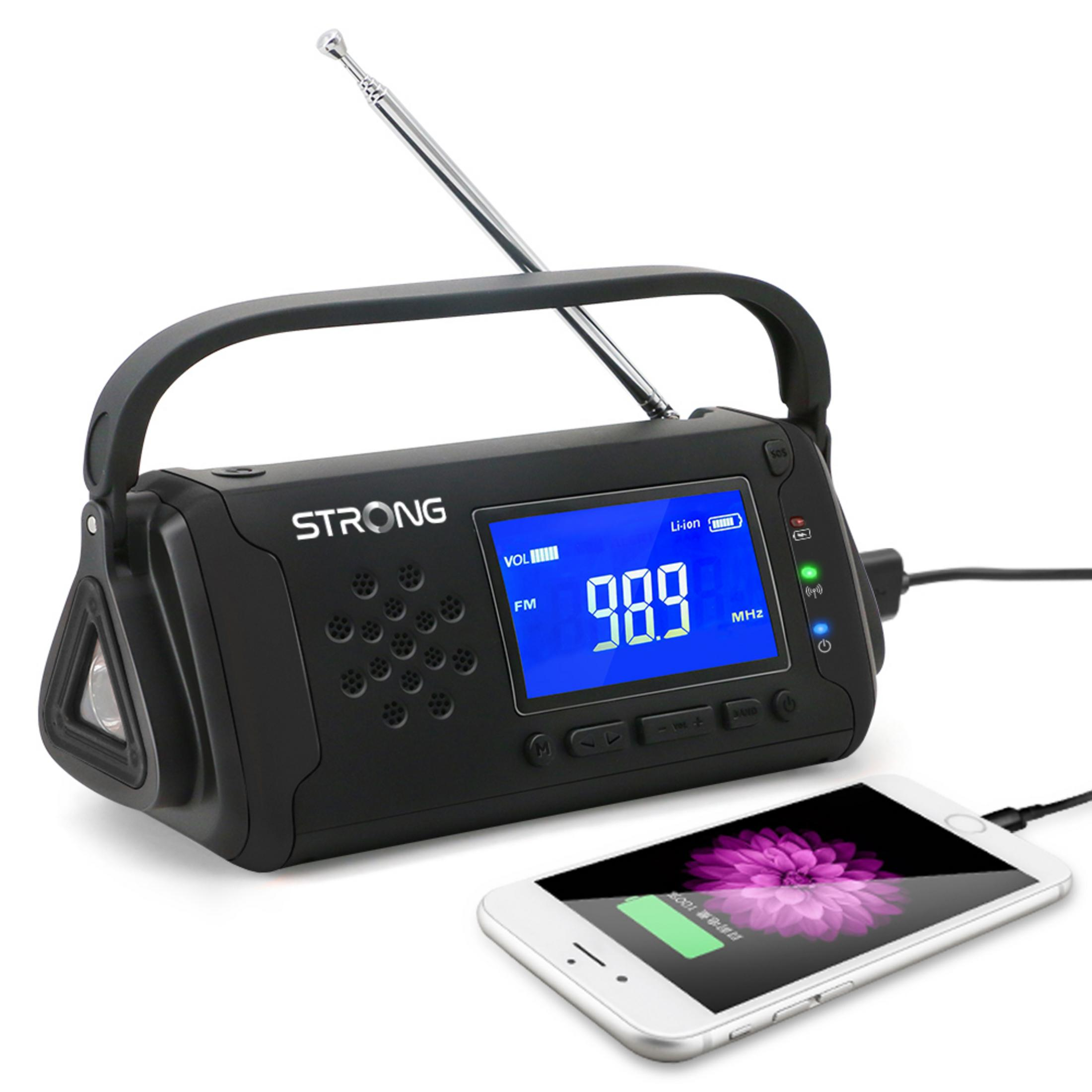 Czarny przenośny radioodbiornik, FM 98.9, ze smartfonem ładującym się obok. Podłączony jest kabel do ładowania.