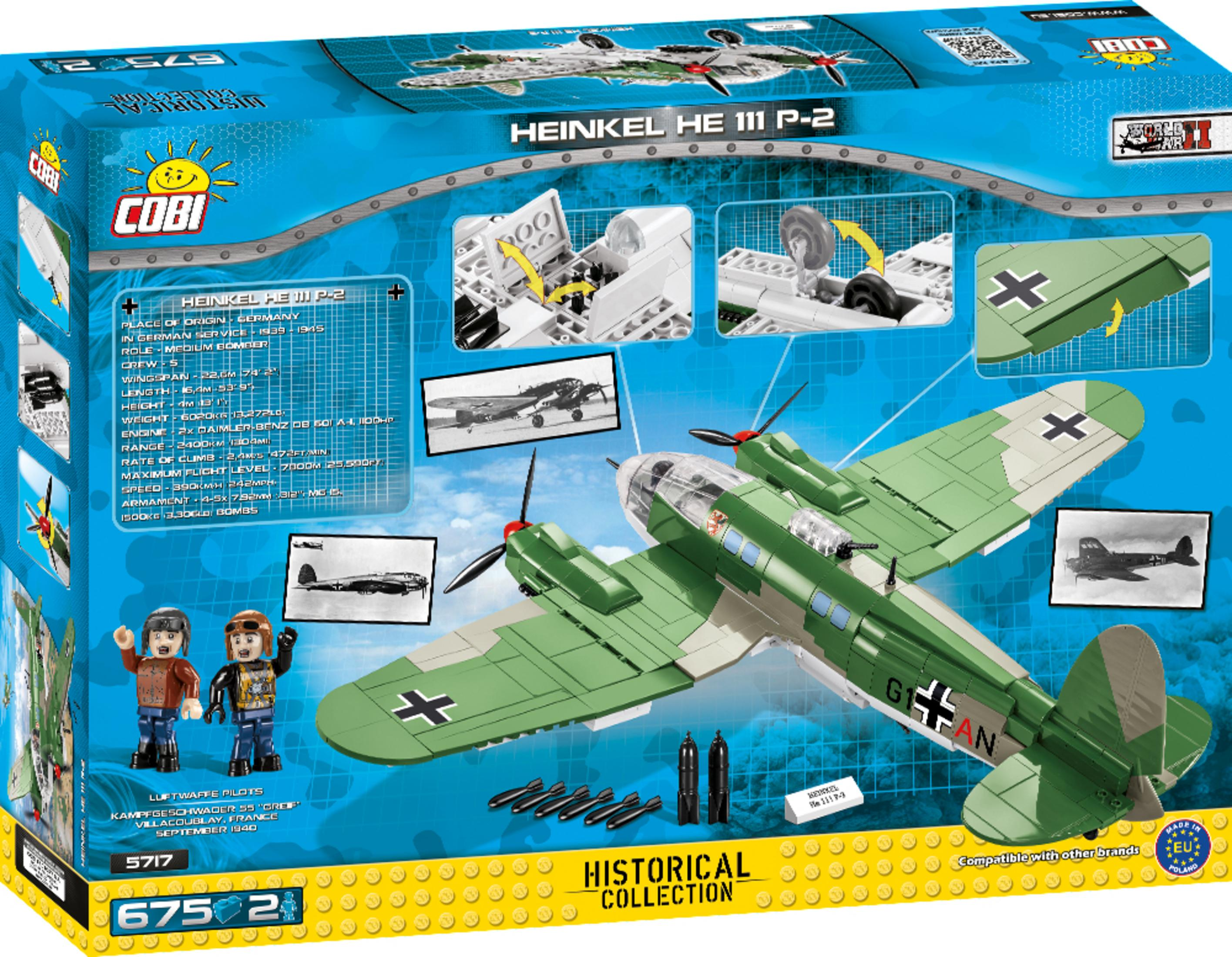 Eine Box mit einem Modellflugzeug darauf. Das Modell ist grün und grau.