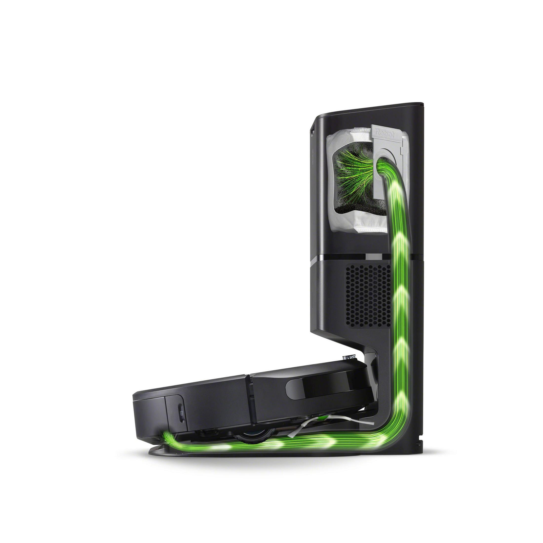 A black robot vacuum cleaner in a charging station. Green lines indicate airflow.