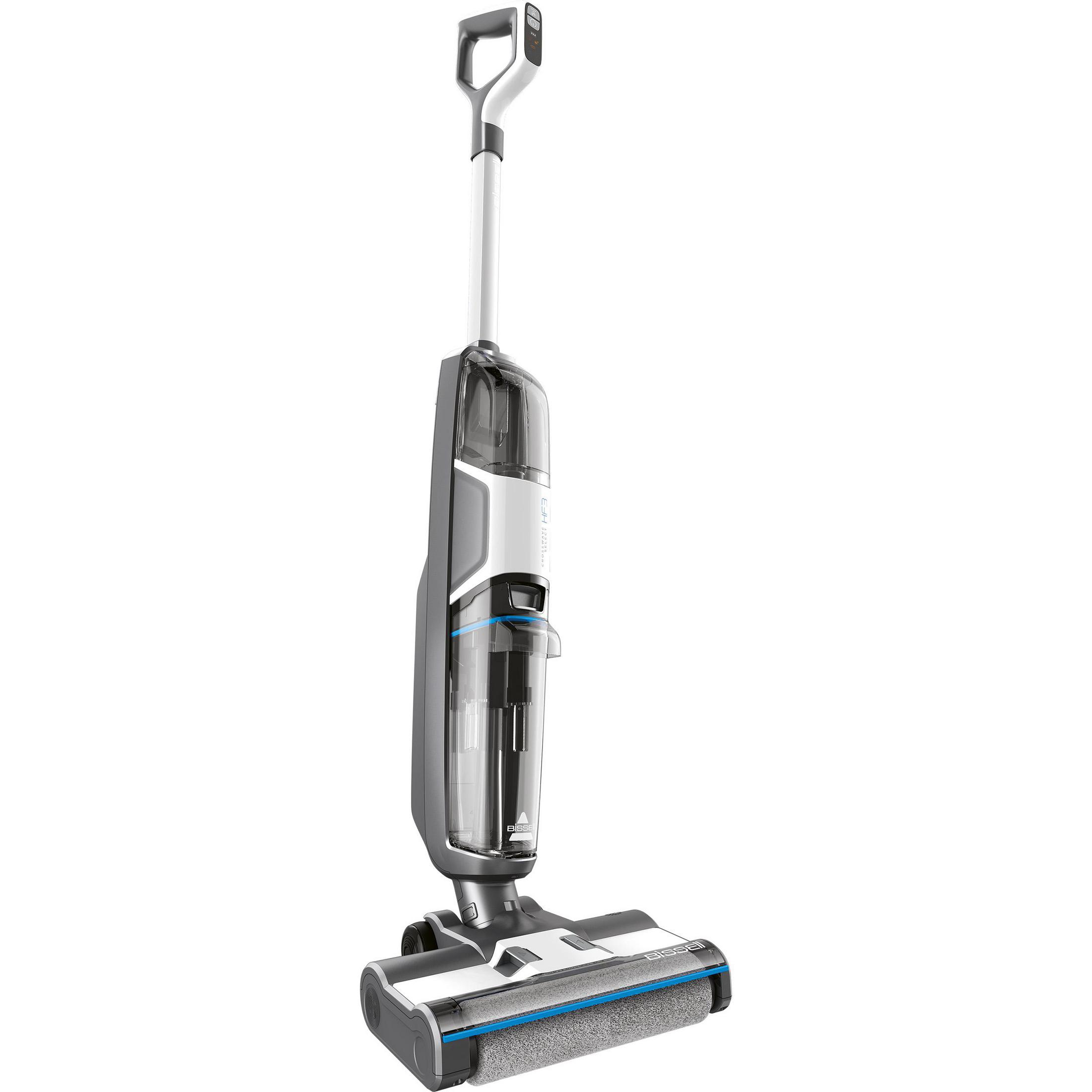 A gray and white stick vacuum cleaner. The background is a white wall.