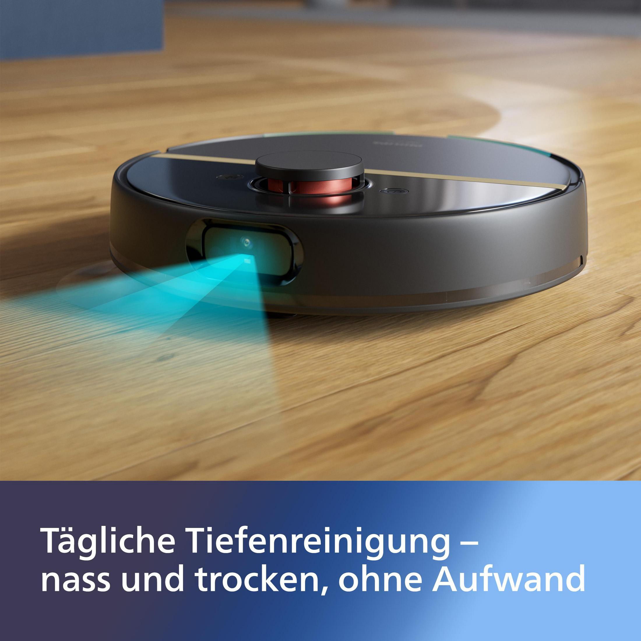 Czarny robot odkurzający na drewnianej podłodze. Niebieskie światło świeci z przodu. Tekst na dole.
