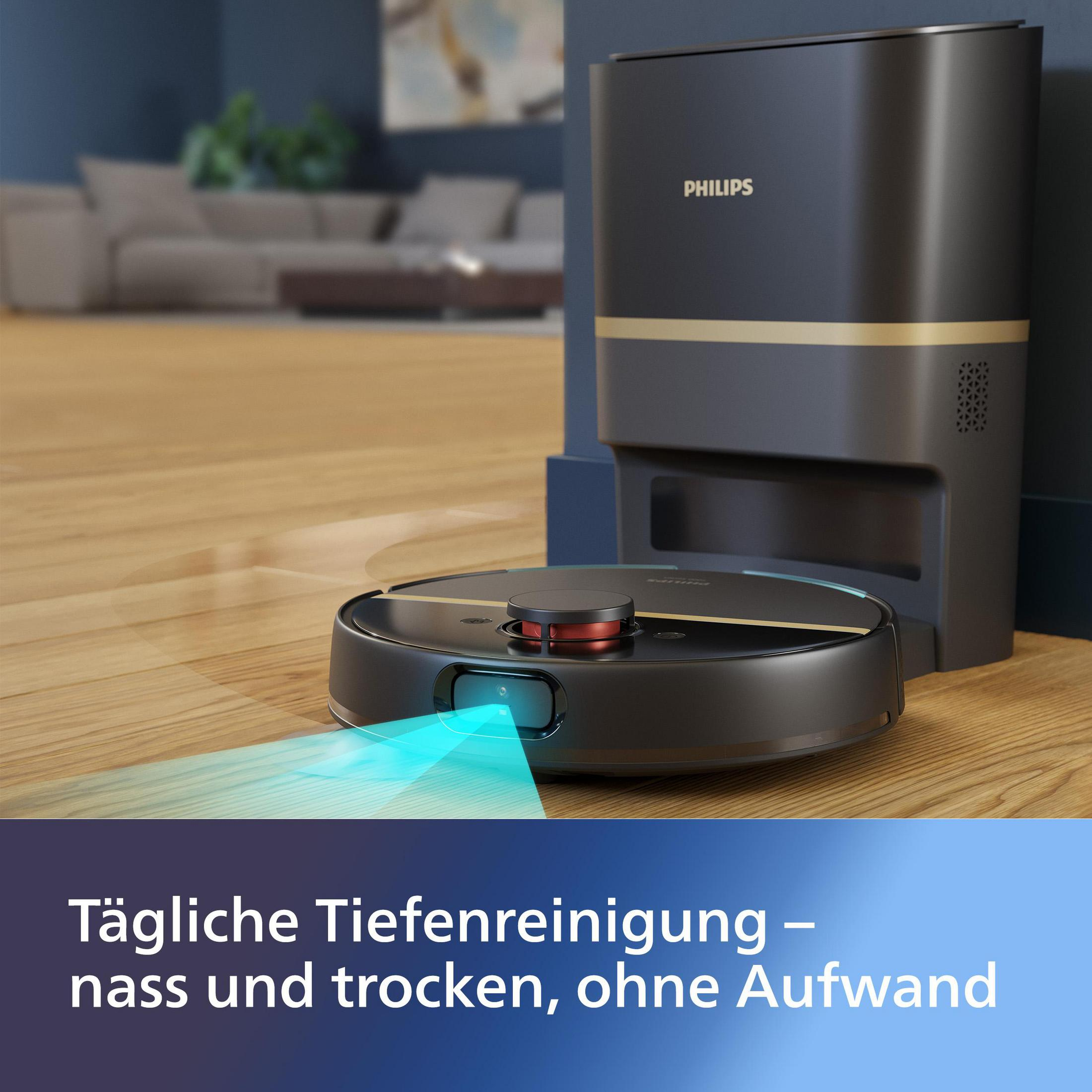 Czarny robot odkurzający emituje niebieskie światło. Stacja ładująca i sofa są w tle. Podłoga jest drewniana.