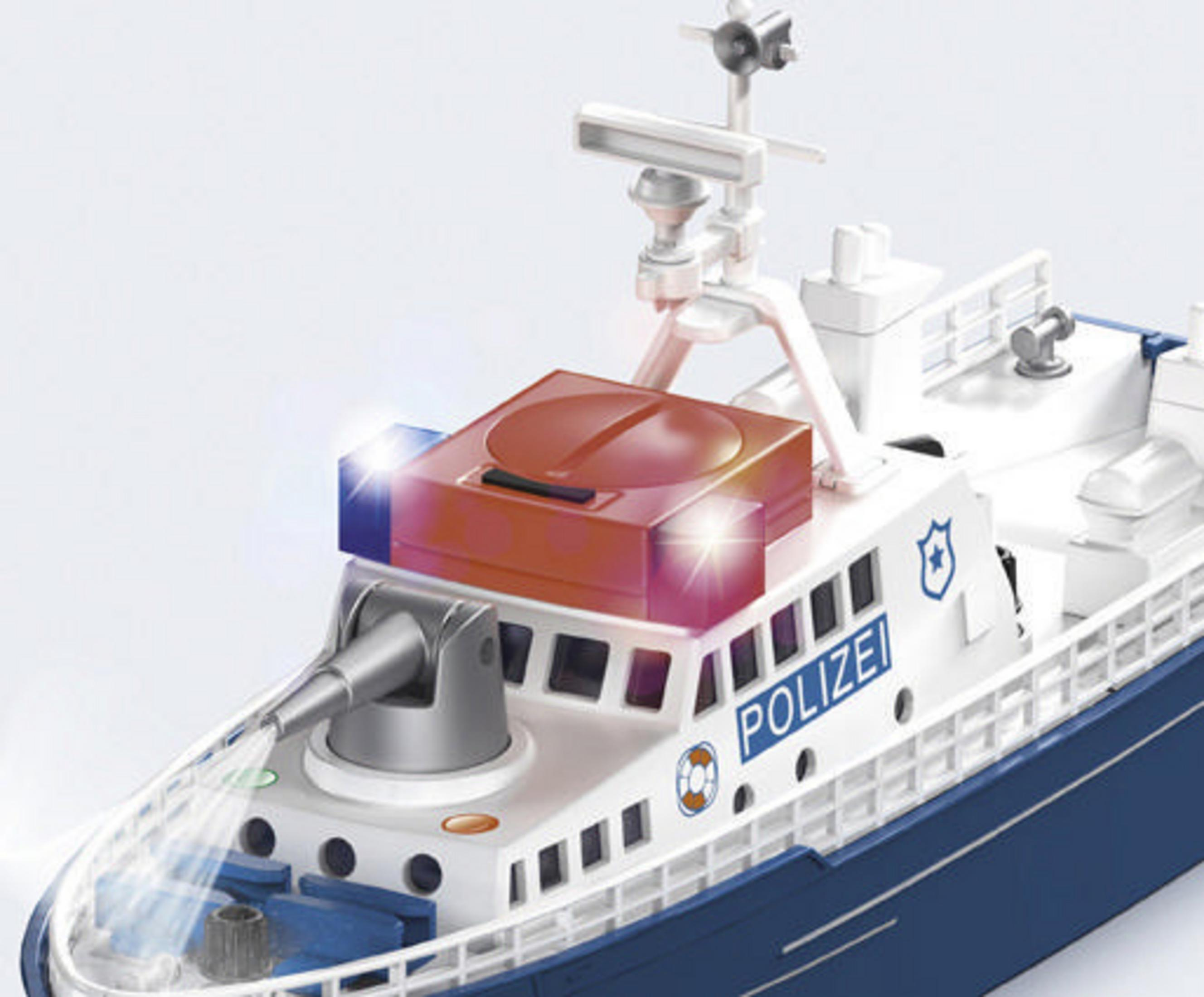 Ein Spielzeug-Polizeiboot mit Lichtern. Das Boot ist weiß und blau, mit POLIZEI drauf.