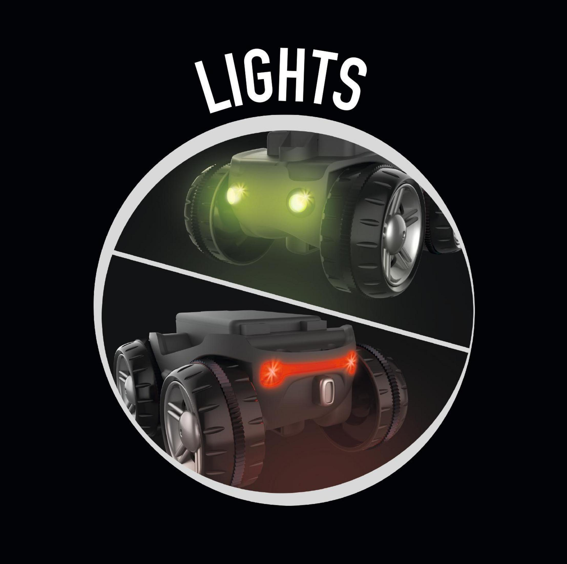 Lichter an einem Spielzeugfahrzeug, grün und rot, vor schwarzem Hintergrund.