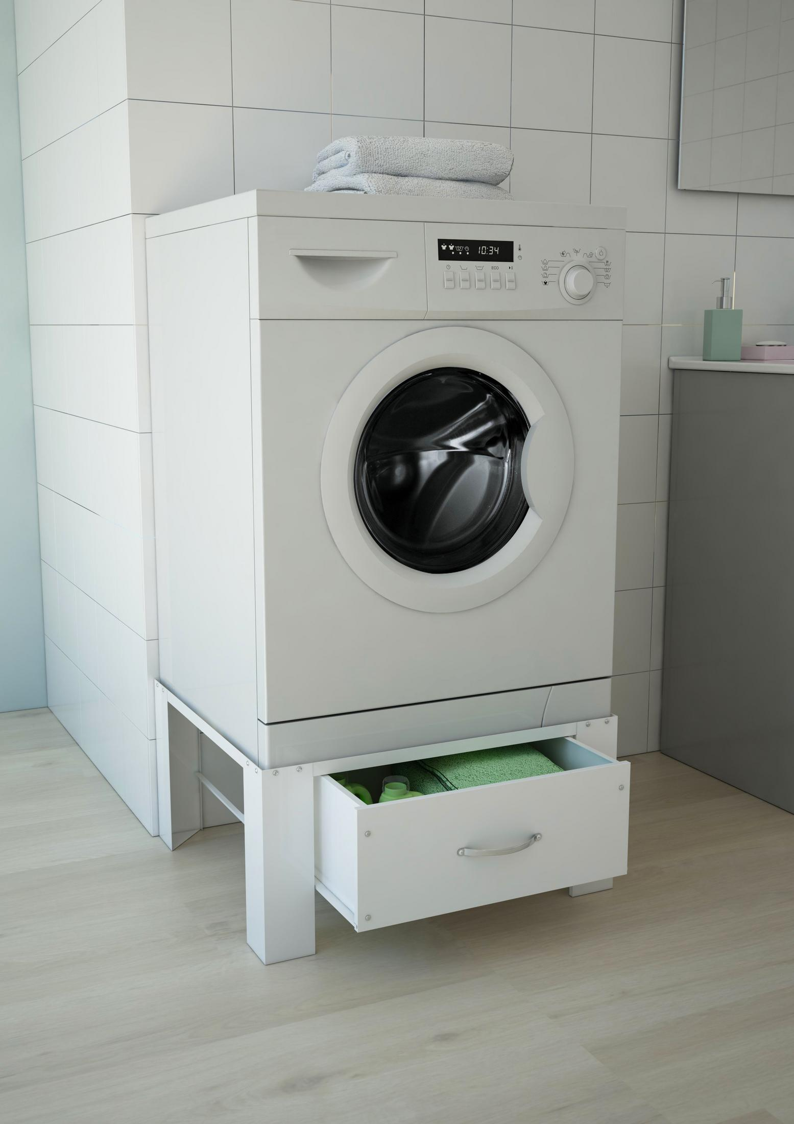 Witte wasmachine met een open lade, met handdoeken en benodigdheden.