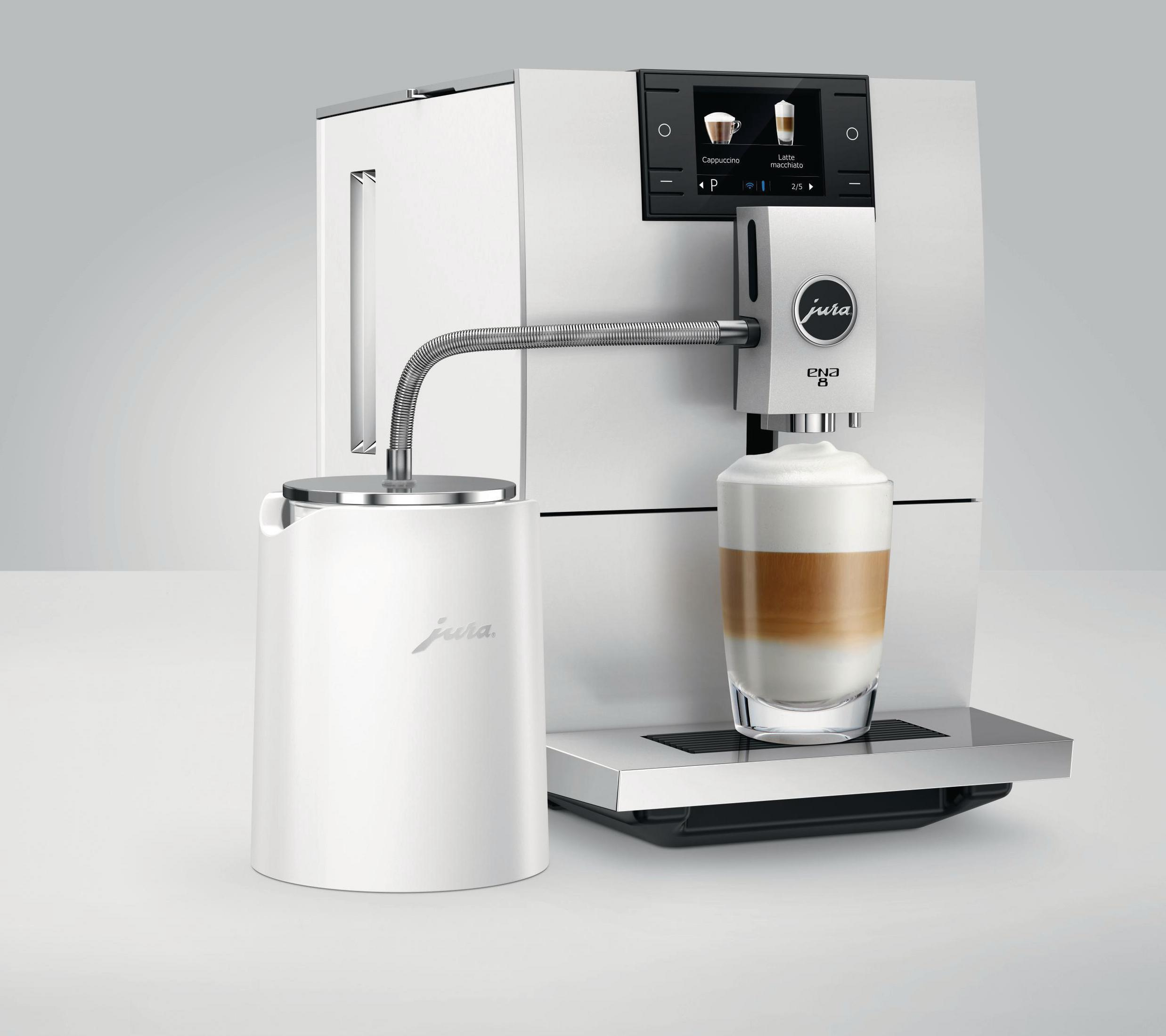Weiße Kaffeemaschine mit einer Tasse Latte und einem Milchaufschäumer.