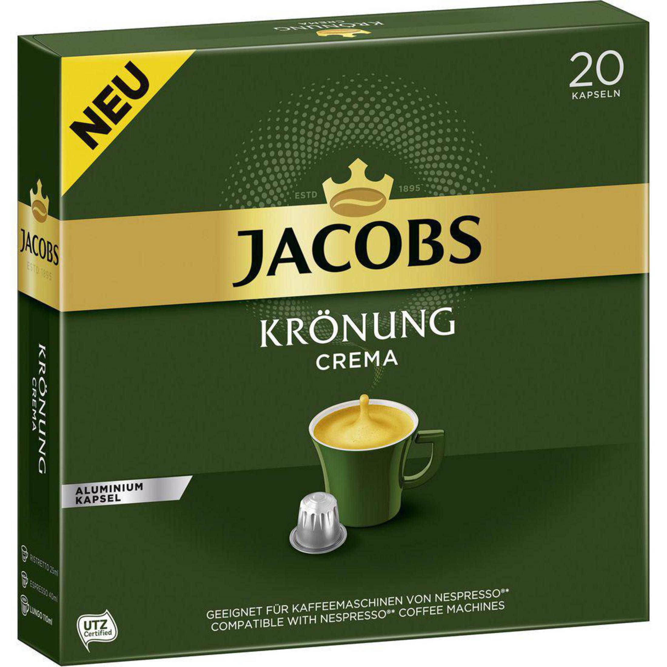 Eine grüne Schachtel mit Jacobs-Kaffeekapseln und eine Kaffeetasse davor.
