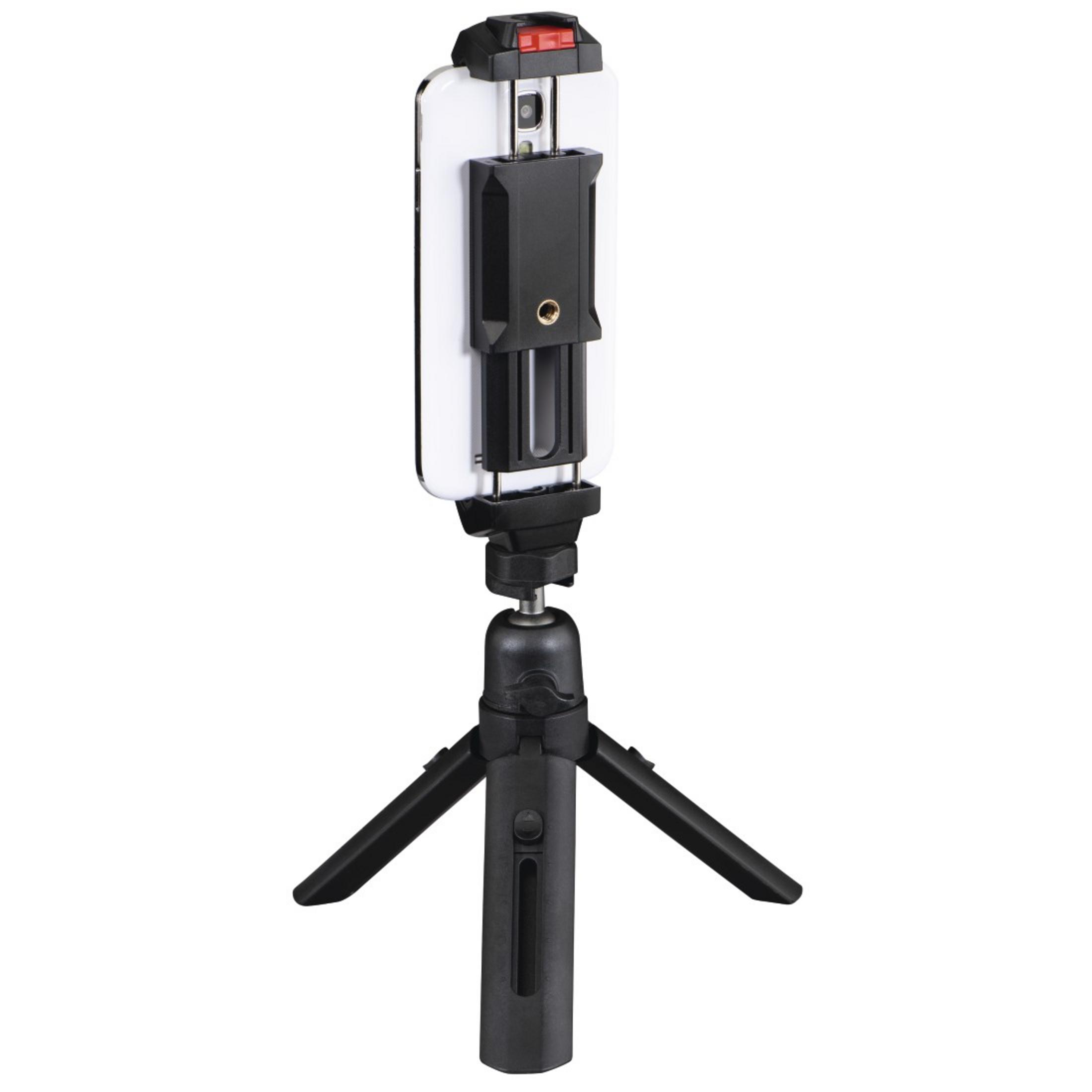 Czarny statyw trzymający biały telefon z czarnym klipsem. Telefon ustawiony pionowo.