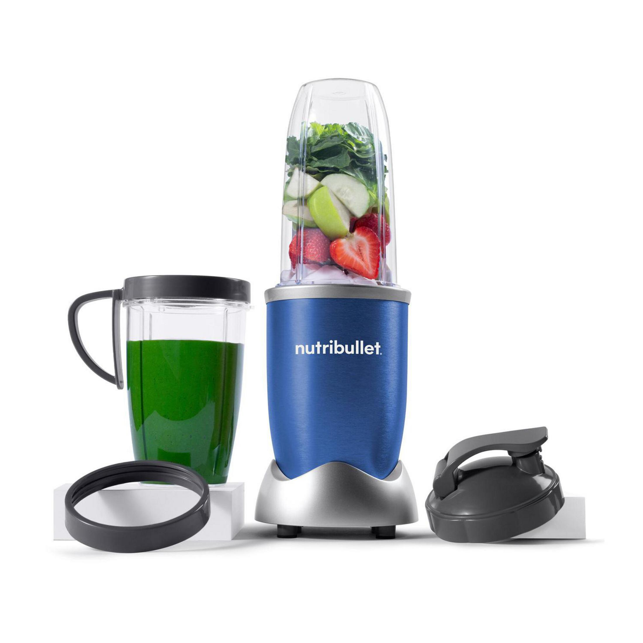 Frullatore blu con ingredienti, una tazza con liquido verde e accessori aggiuntivi.