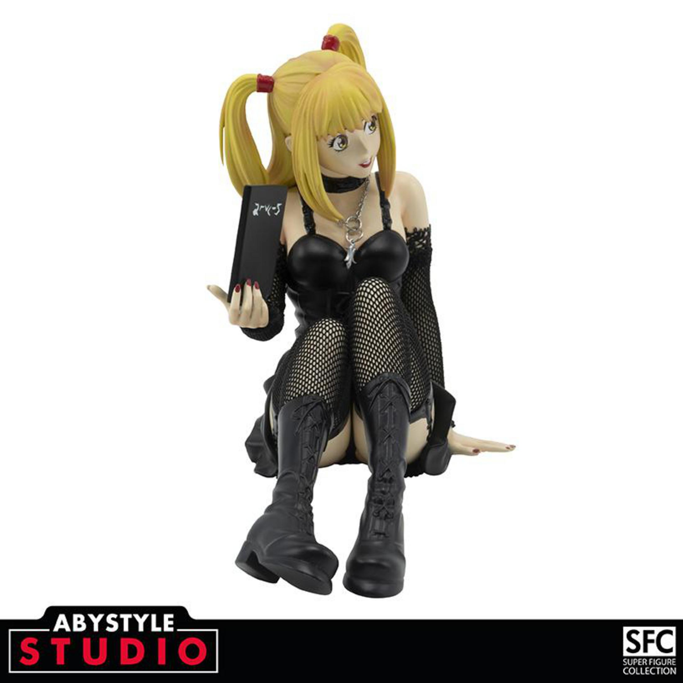 Anime-Figur einer Frau, die ein Notizbuch hält. Sie hat gelbes Haar und trägt schwarze Kleidung.