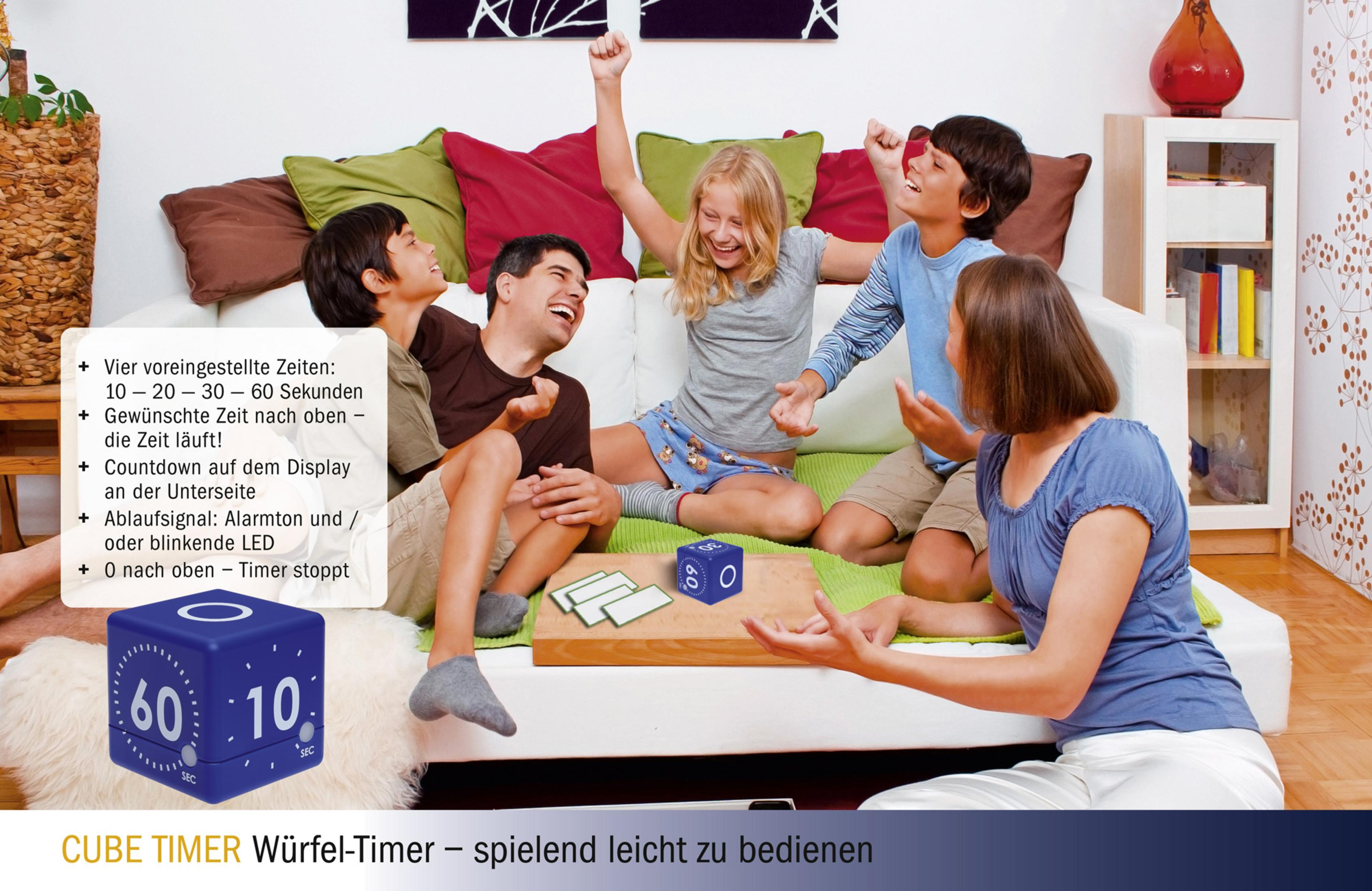 Eine Gruppe von Kindern und Erwachsenen spielt ein Spiel mit einem blauen Würfel-Timer.