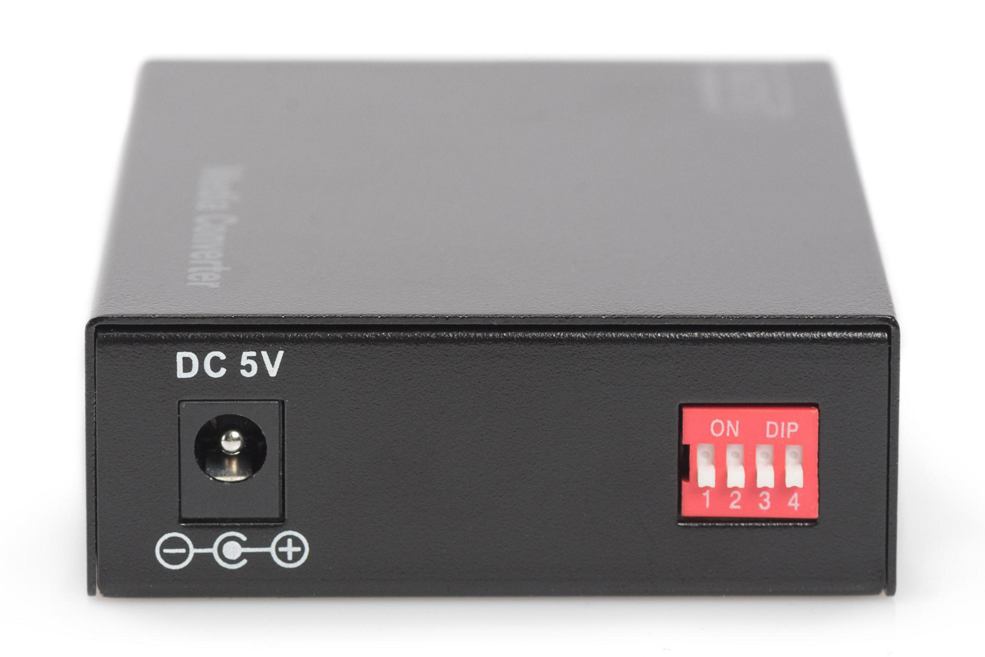 Schwarzer Medienkonverter mit DC 5V Eingang, DIP-Schaltern und Beschriftungen. Das Gerät liegt auf weißem Grund.