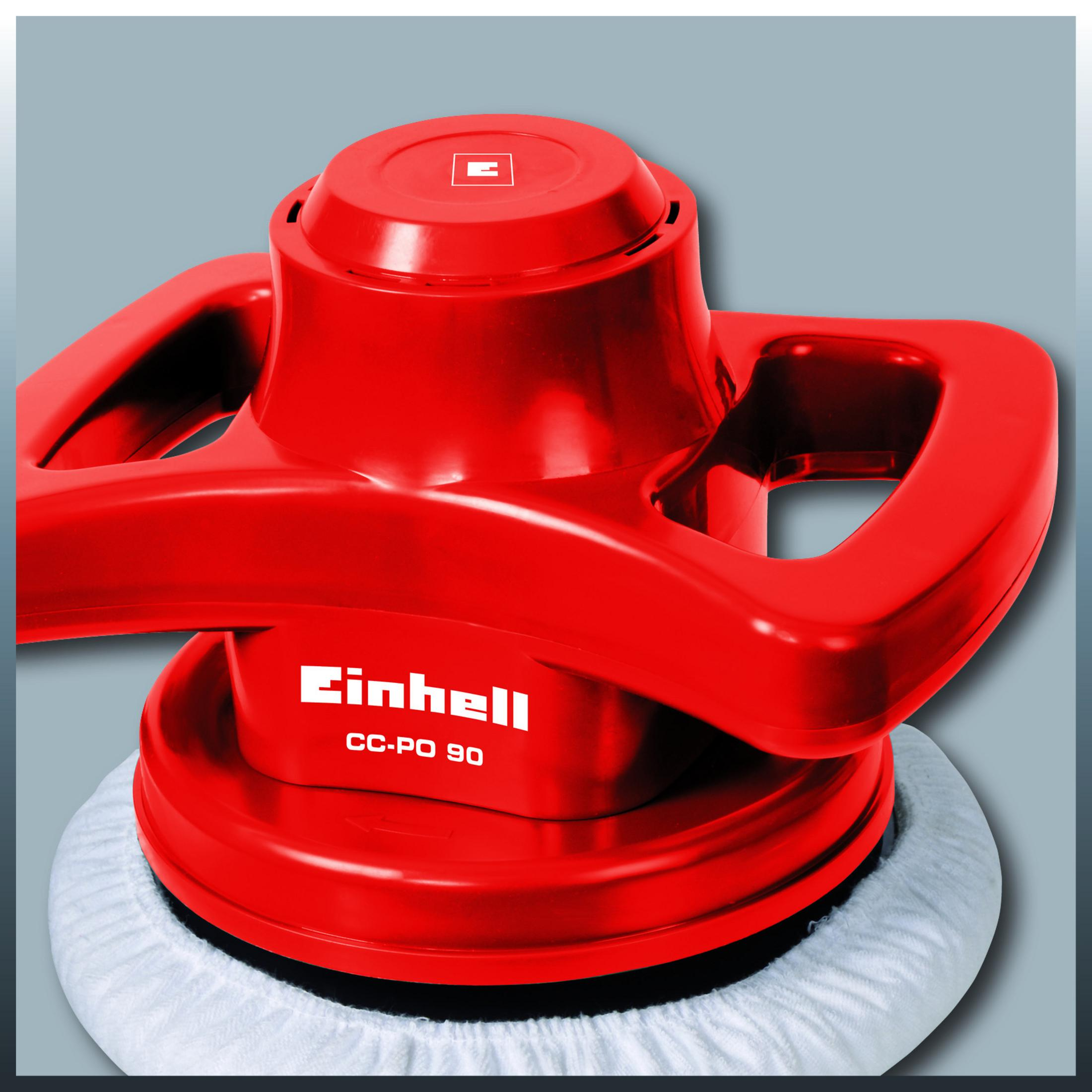 Ein roter Einhell CC-PO 90 Polierer. Er hat ein weißes Polierpad und Griffe. Der Hintergrund ist grau.