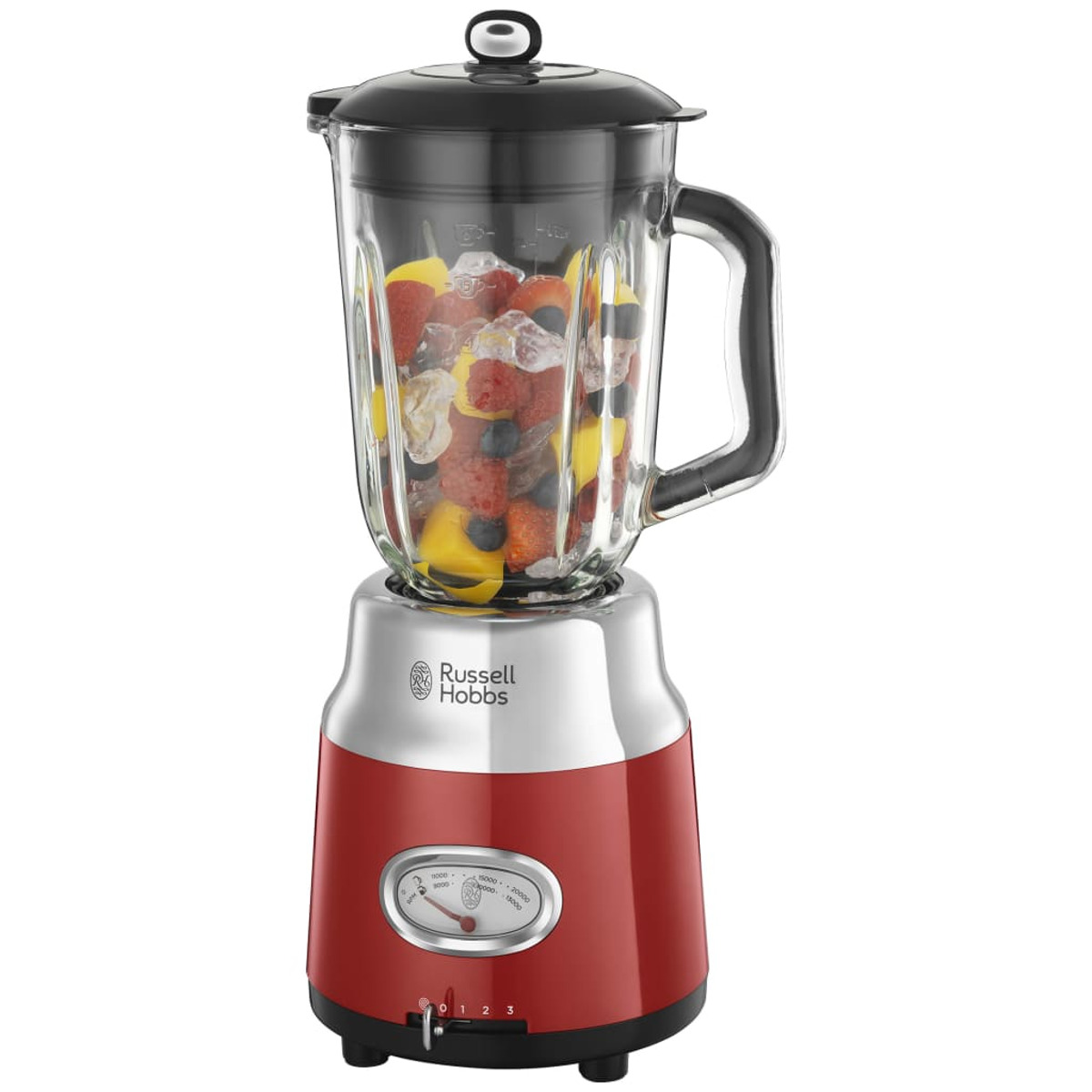 Meyve ve buzla dolu bir cam kavanozlu kırmızı bir blender. Blenderin kırmızı bir tabanı var.