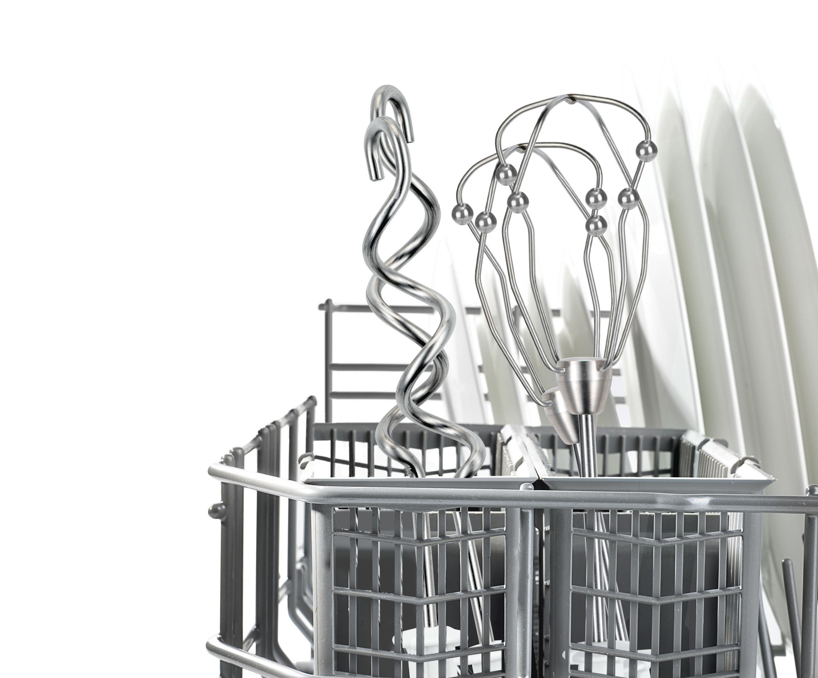 A dishwasher basket with utensils. It contains a spiral and whisk. Plates are in the back.
