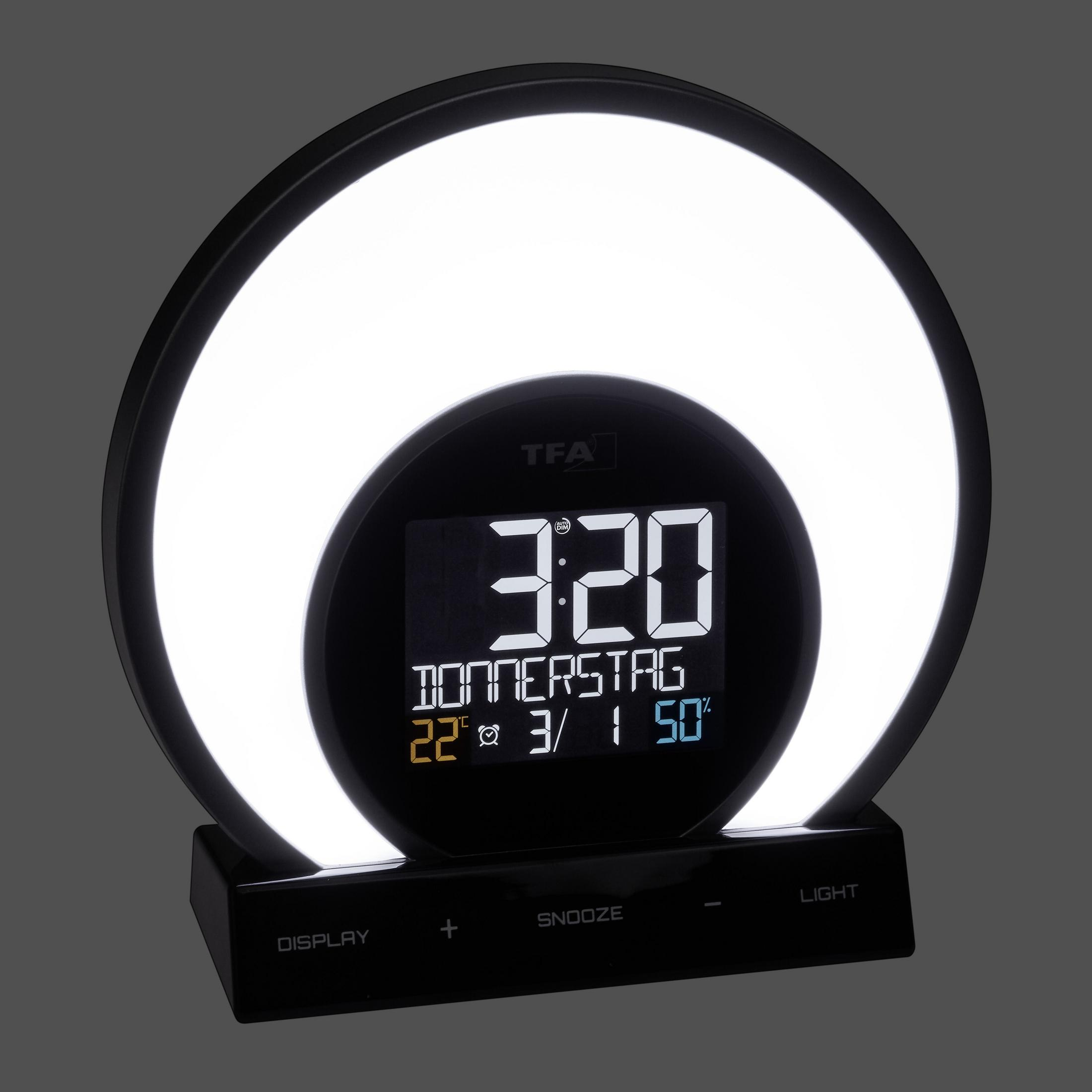 Ein schwarzer Wecker mit kreisförmigem Licht und Digitalanzeige mit Uhrzeit und Datum.