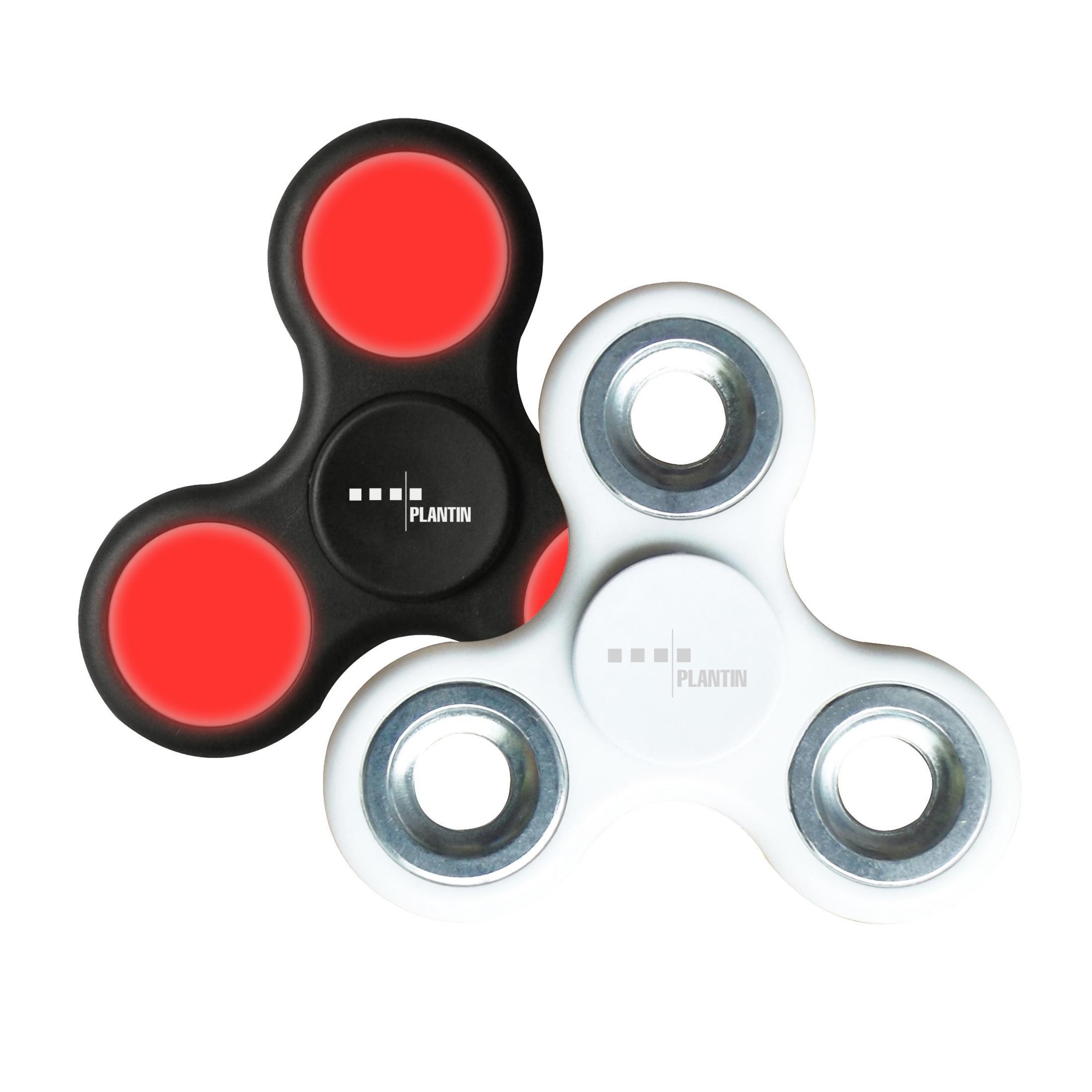 Zwei Fidget Spinner. Einer schwarz mit roten Lichtern, einer weiß. Beide mit PLANIT Logo.