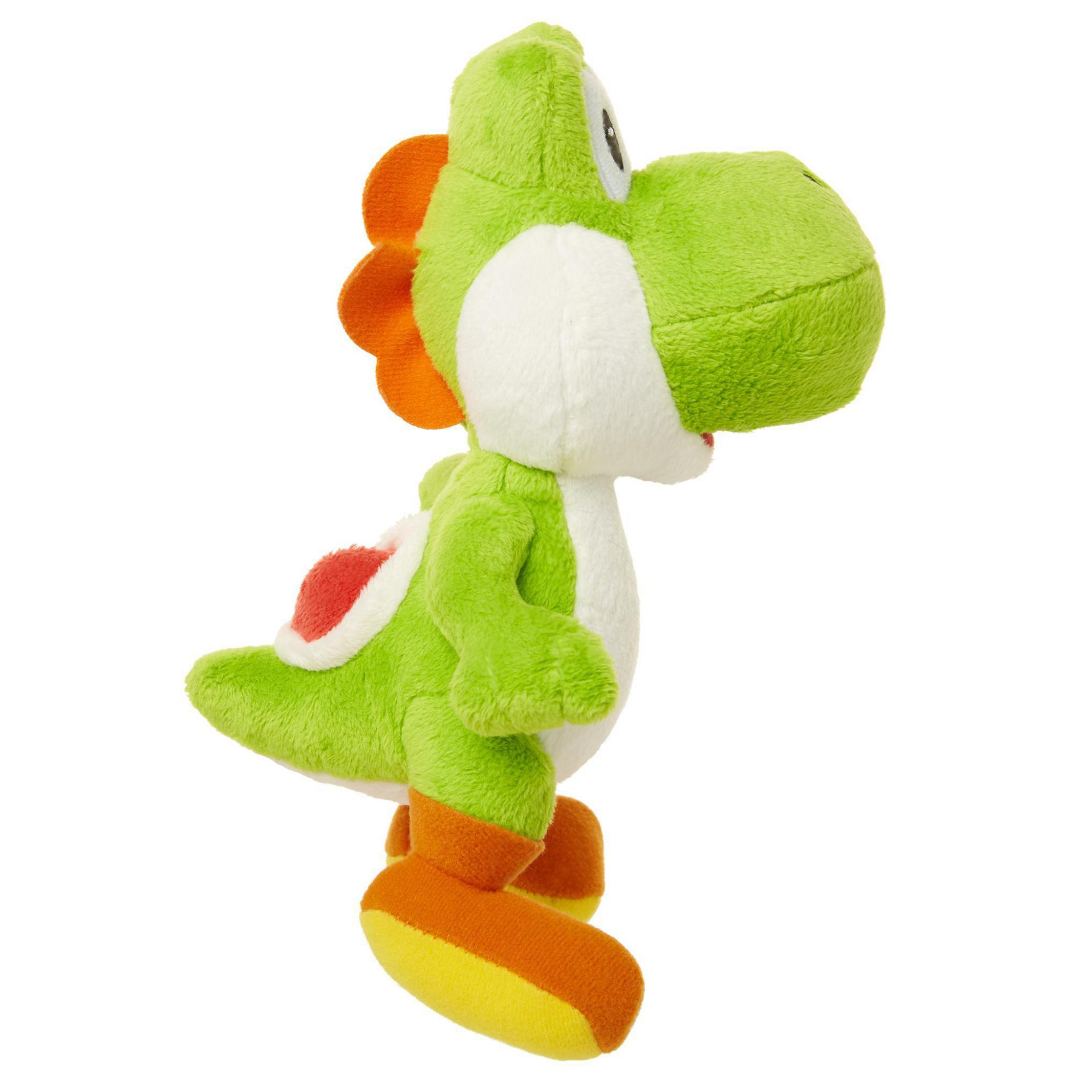 Grünes Yoshi-Plüschtier, weißer Bauch, orangefarbene Akzente, gelbe Füße, Seitenansicht.