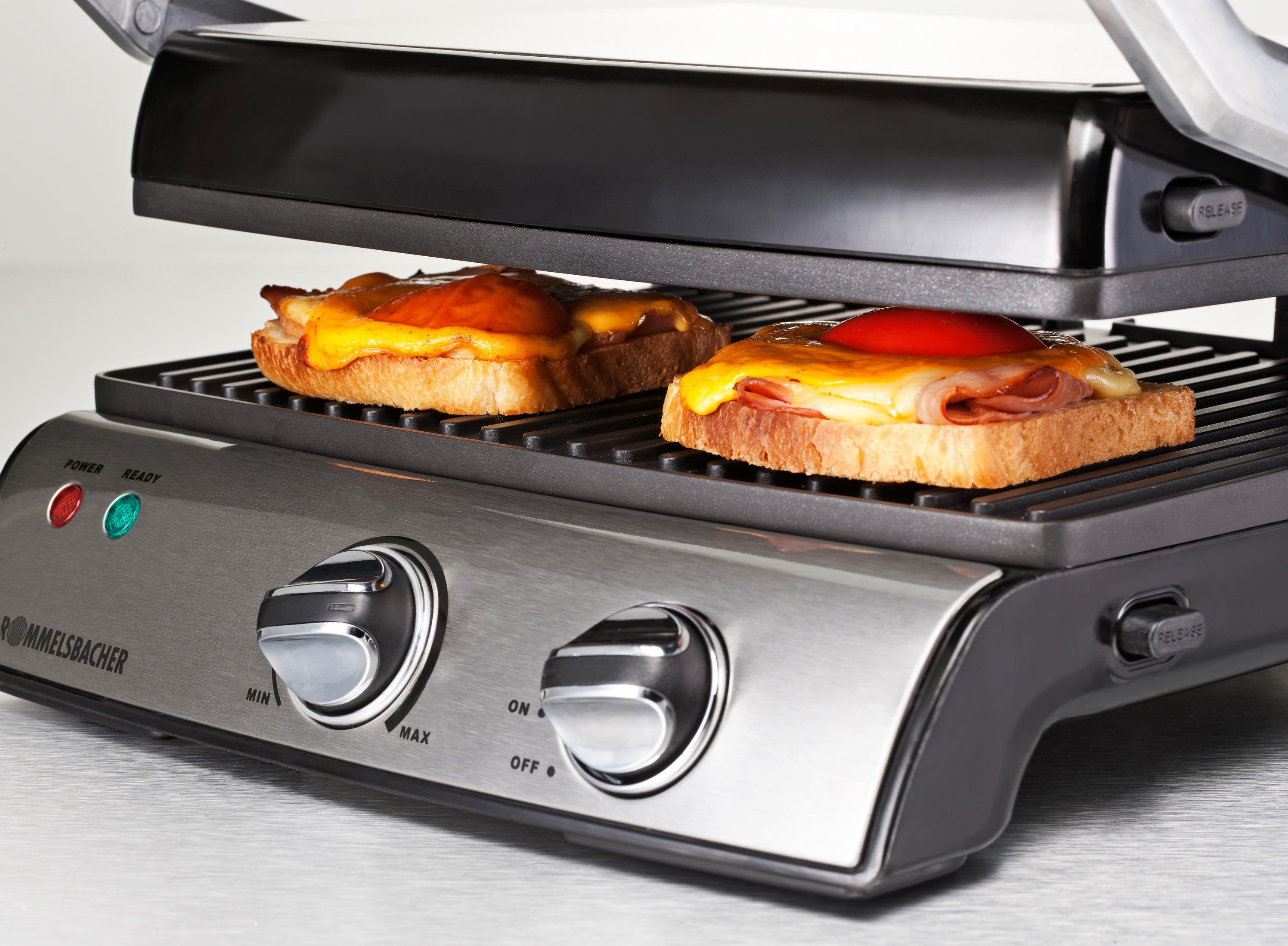 Grill do panini z dwiema kanapkami. Jedna z serem, druga z pomidorem.