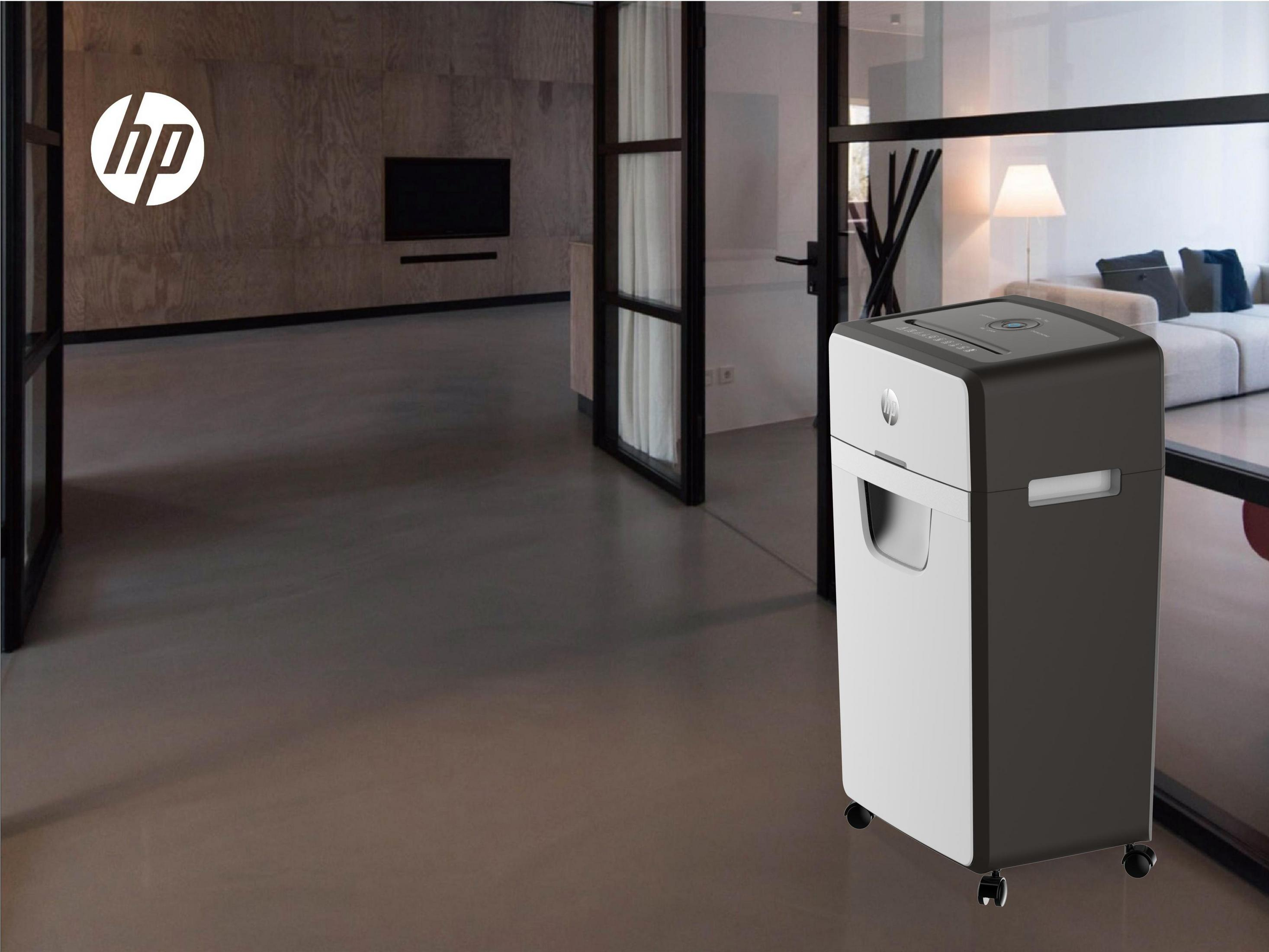 Destructeur HP dans un bureau moderne, à côté d'une porte vitrée.