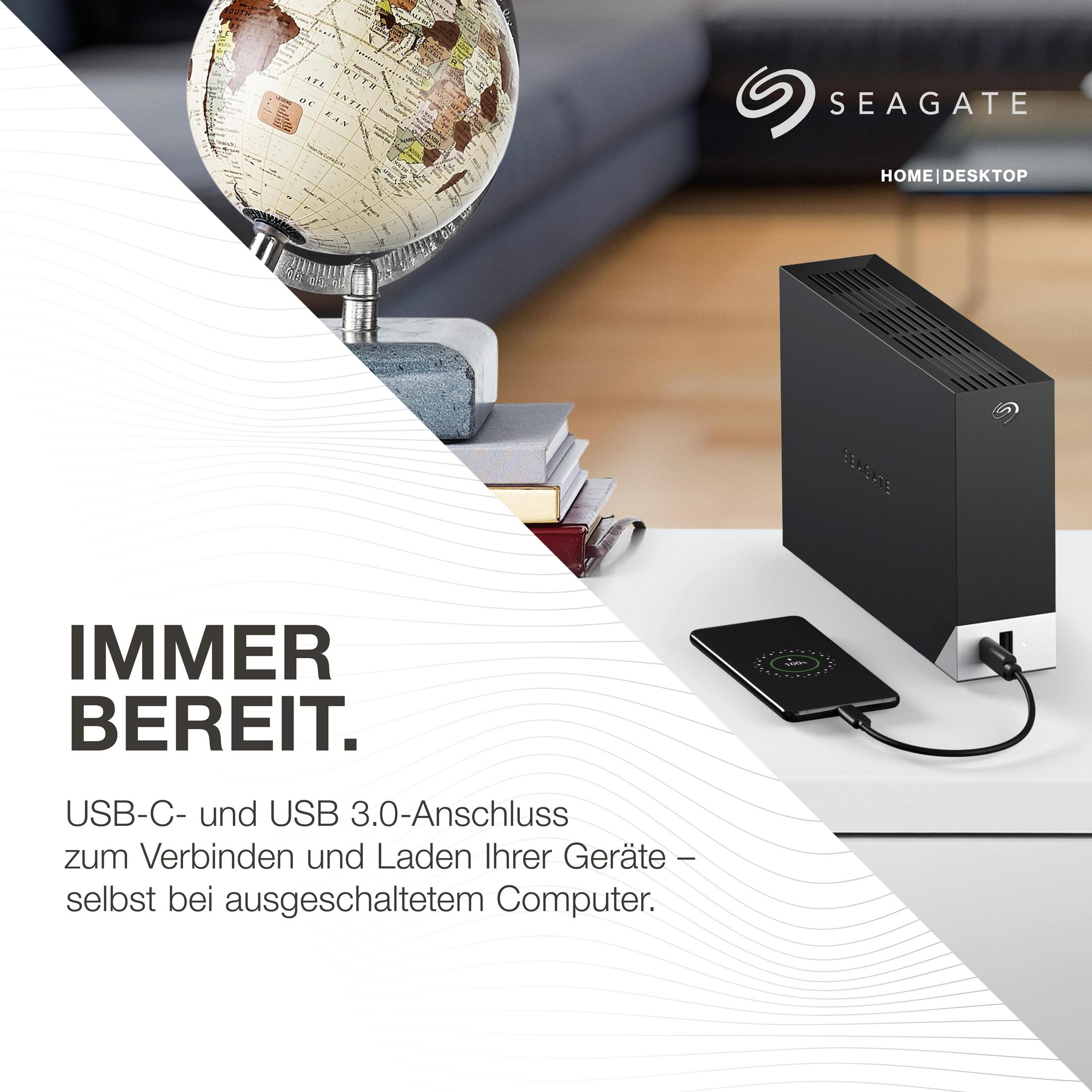 Biurko z globusem, książkami, czarnym dyskiem zewnętrznym i ładującym się telefonem.