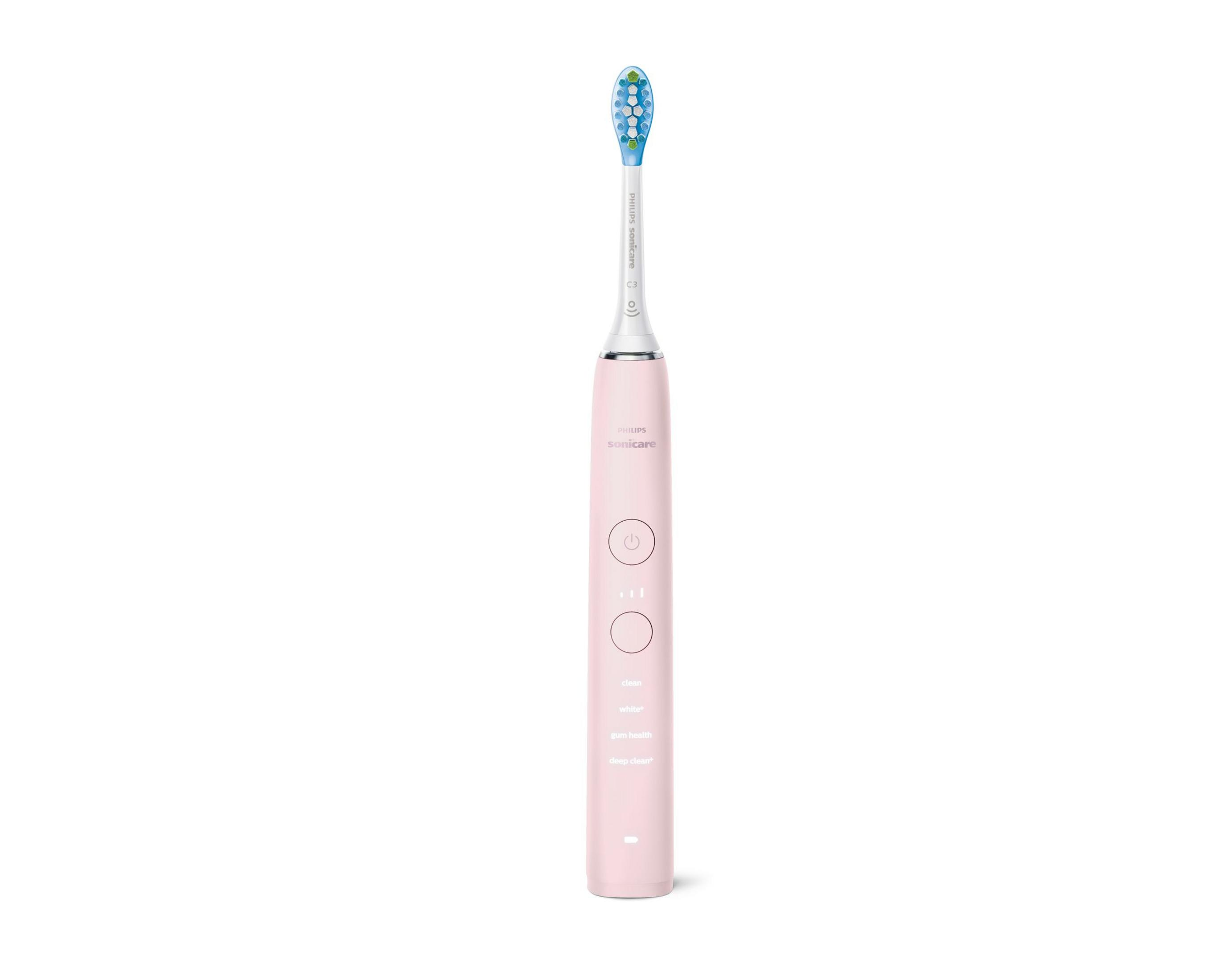 Spazzolino elettrico rosa con pulsanti e testina blu su sfondo bianco.