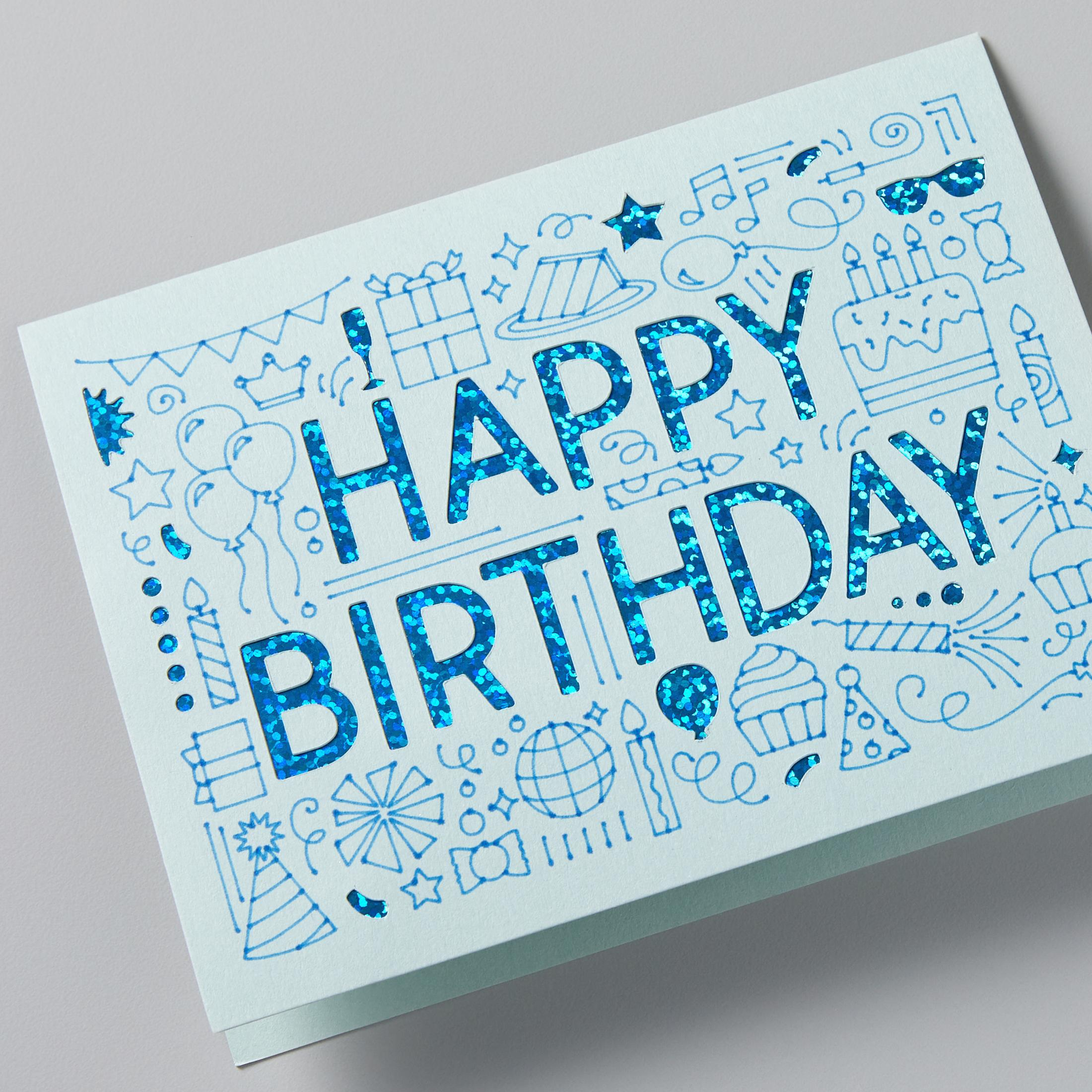 Eine blaue Geburtstagskarte mit blauen Kritzeleien, die "Happy Birthday" in glitzernden blauen Buchstaben lesen.