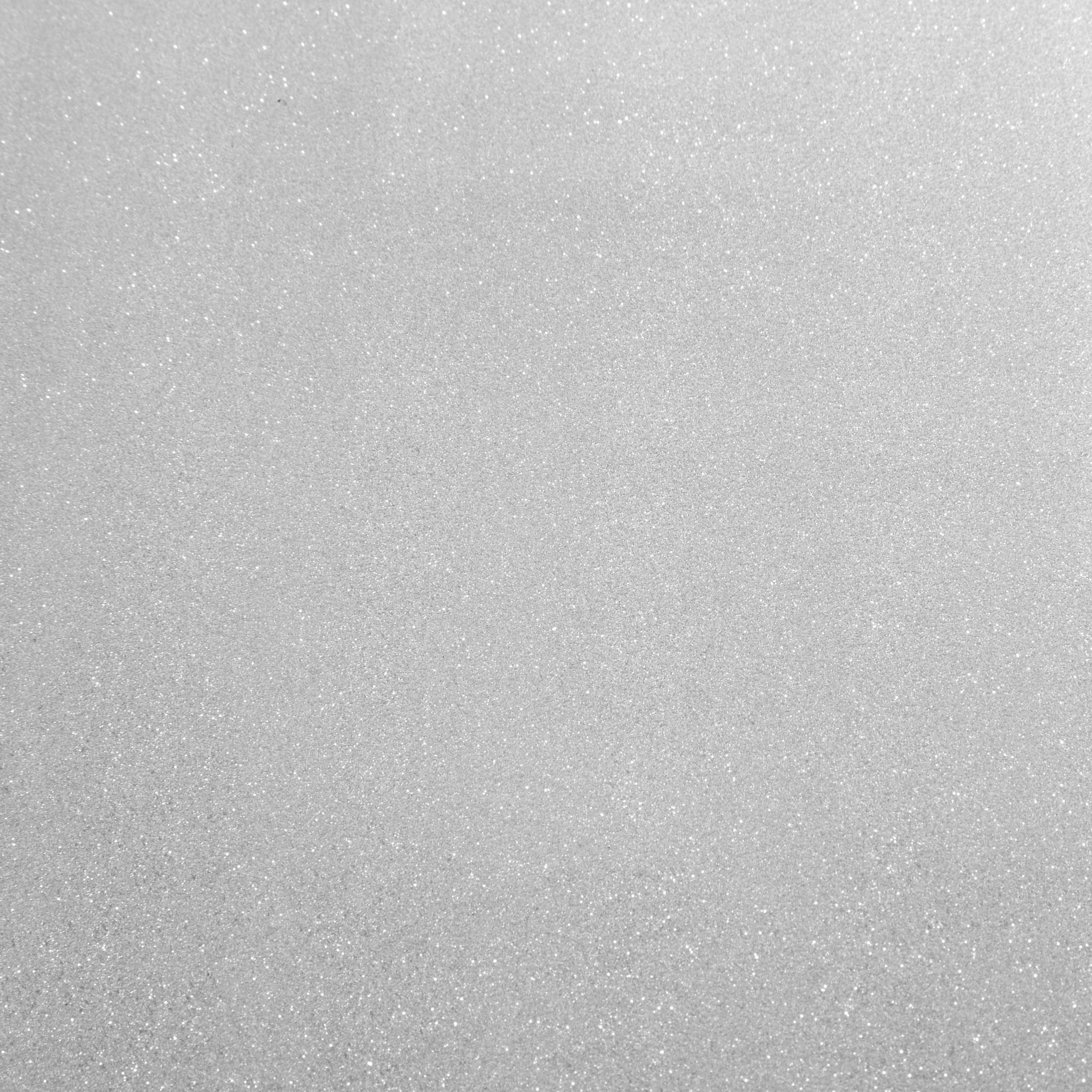 Eine gleichmäßig strukturierte Oberfläche in Grau- und Weißtönen mit kleinen, glitzernden Details.