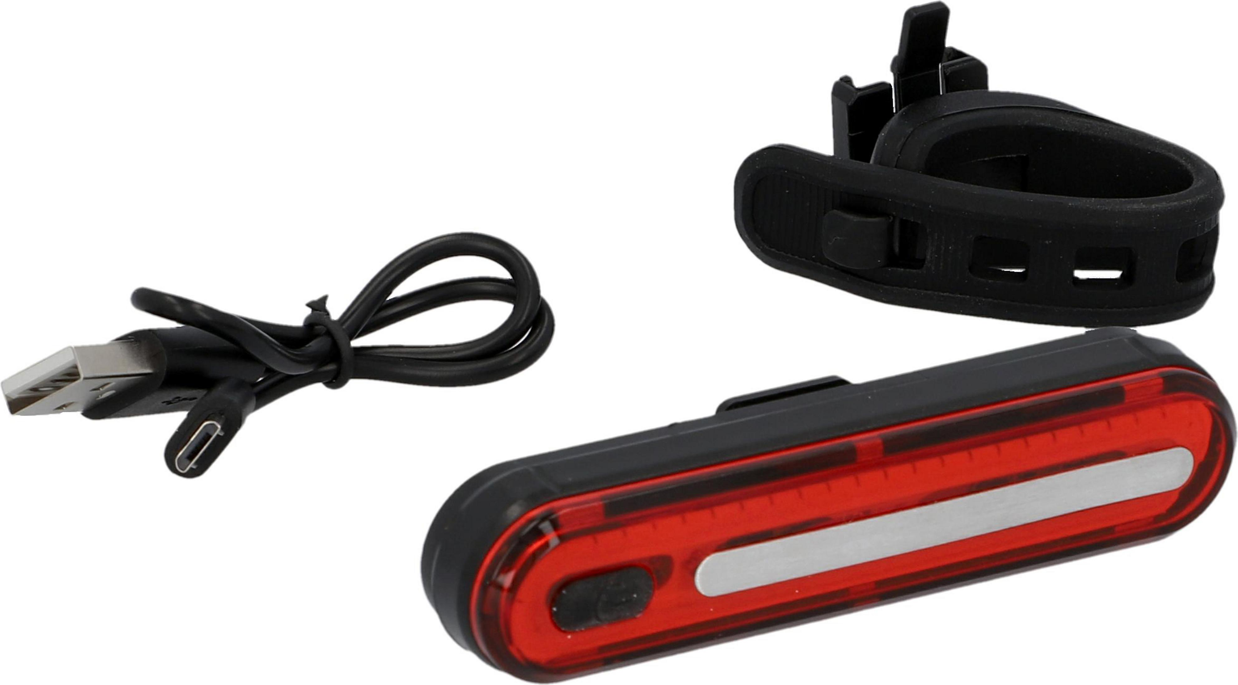 Fahrradlicht, USB-Kabel und Halterung auf weißer Oberfläche.