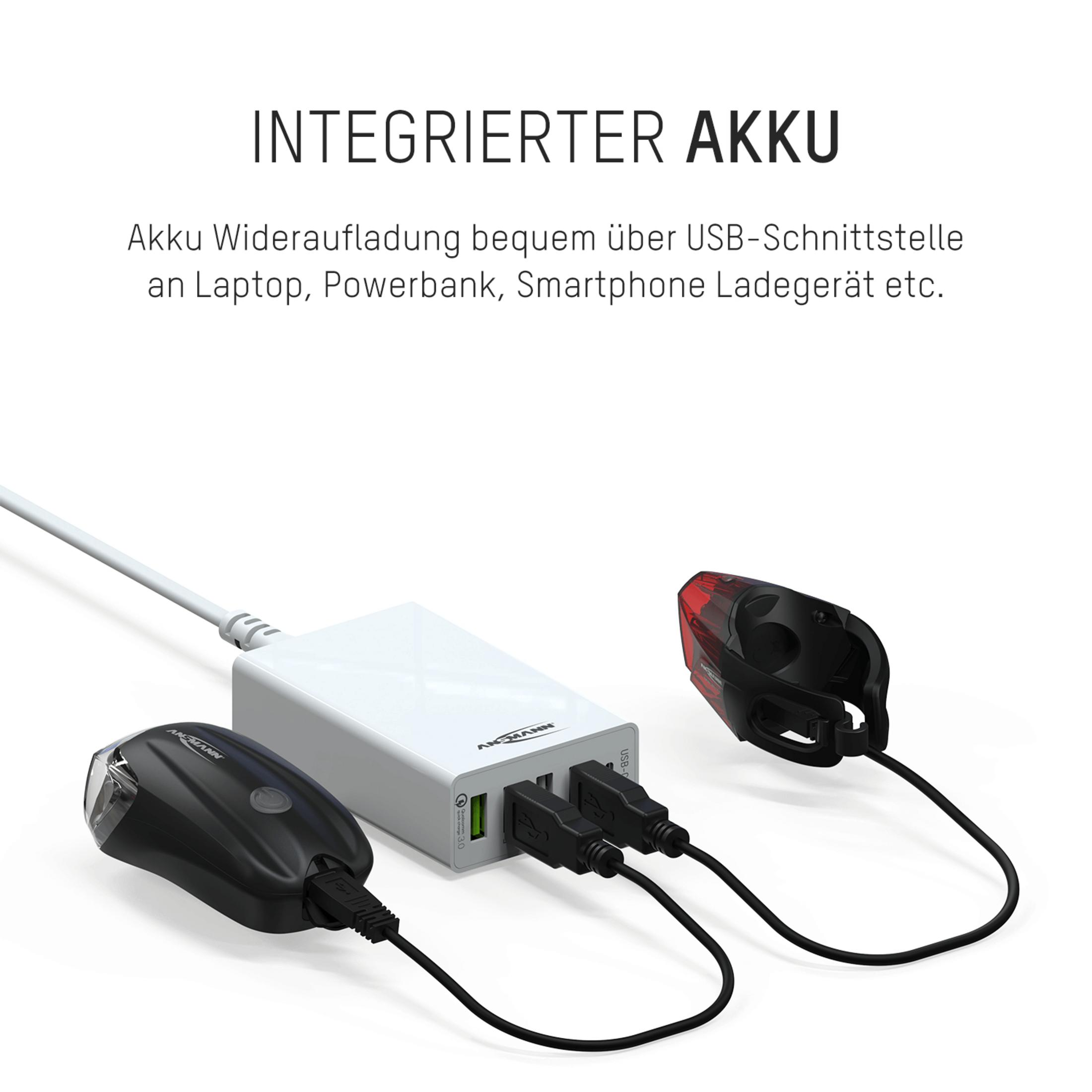 Biały power bank ładujący czarne światła rowerowe. Tekst: 'INTEGRIERTER AKKU'.