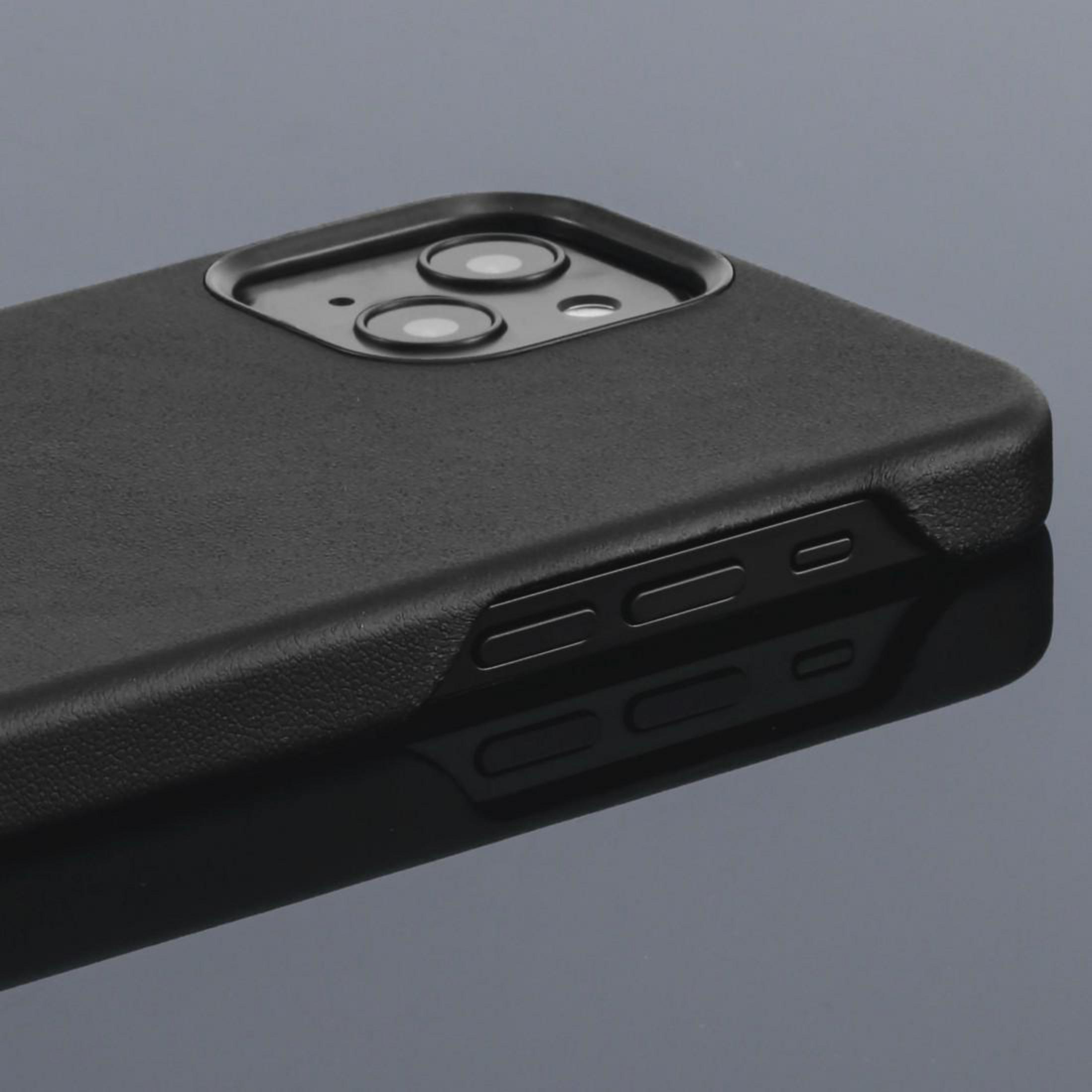 Czarna obudowa telefonu z wycięciami na aparat i bocznymi przyciskami, odbijająca się na powierzchni.