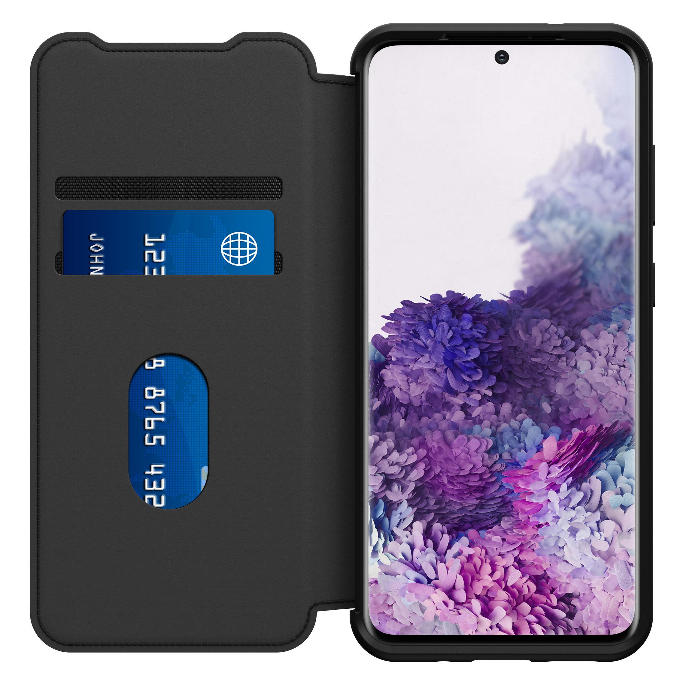 Custodia nera aperta con carte di credito. Telefono visibile. Sfondo nero.