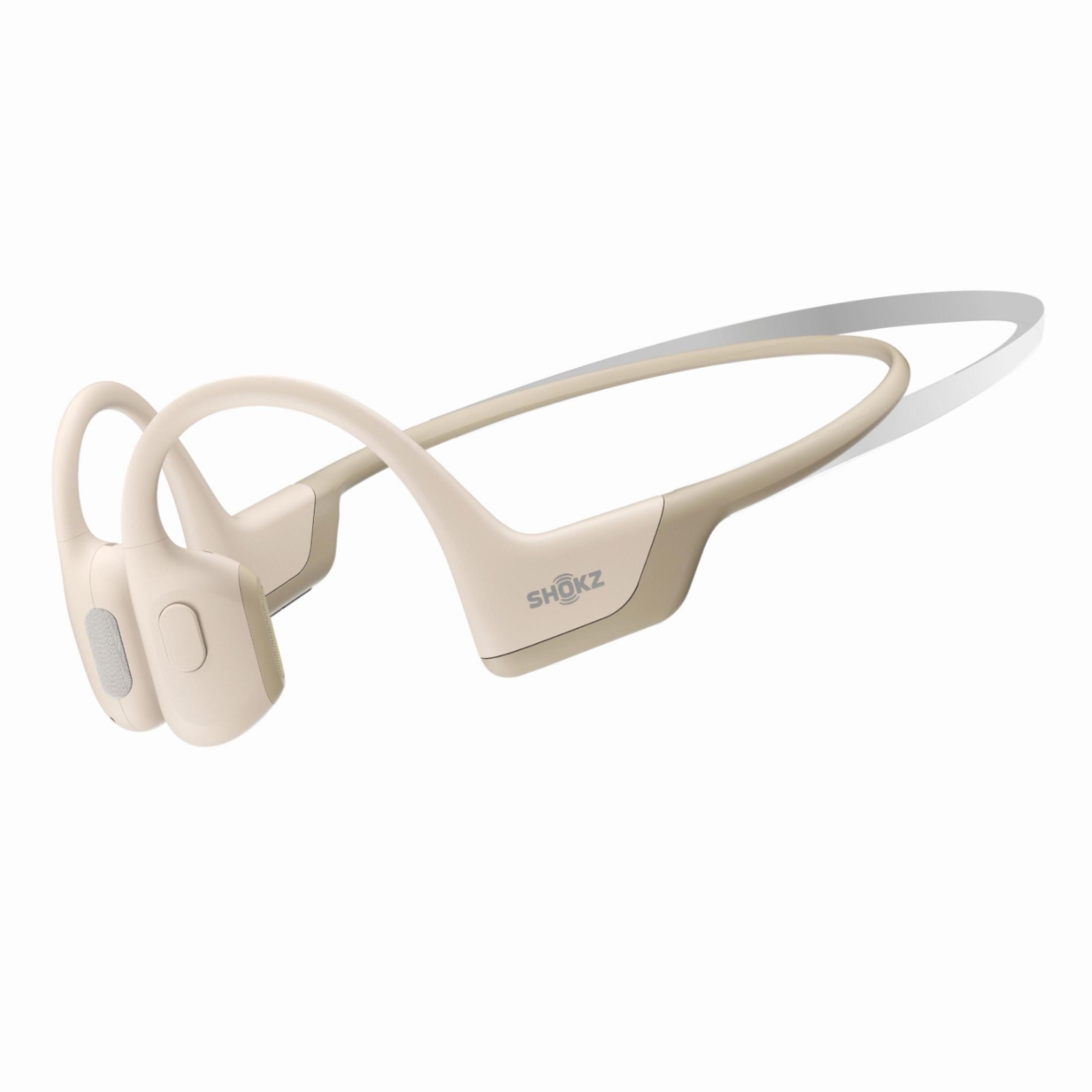 Cuffie a conduzione ossea beige. Il marchio 'SHOKZ' è sul lato.