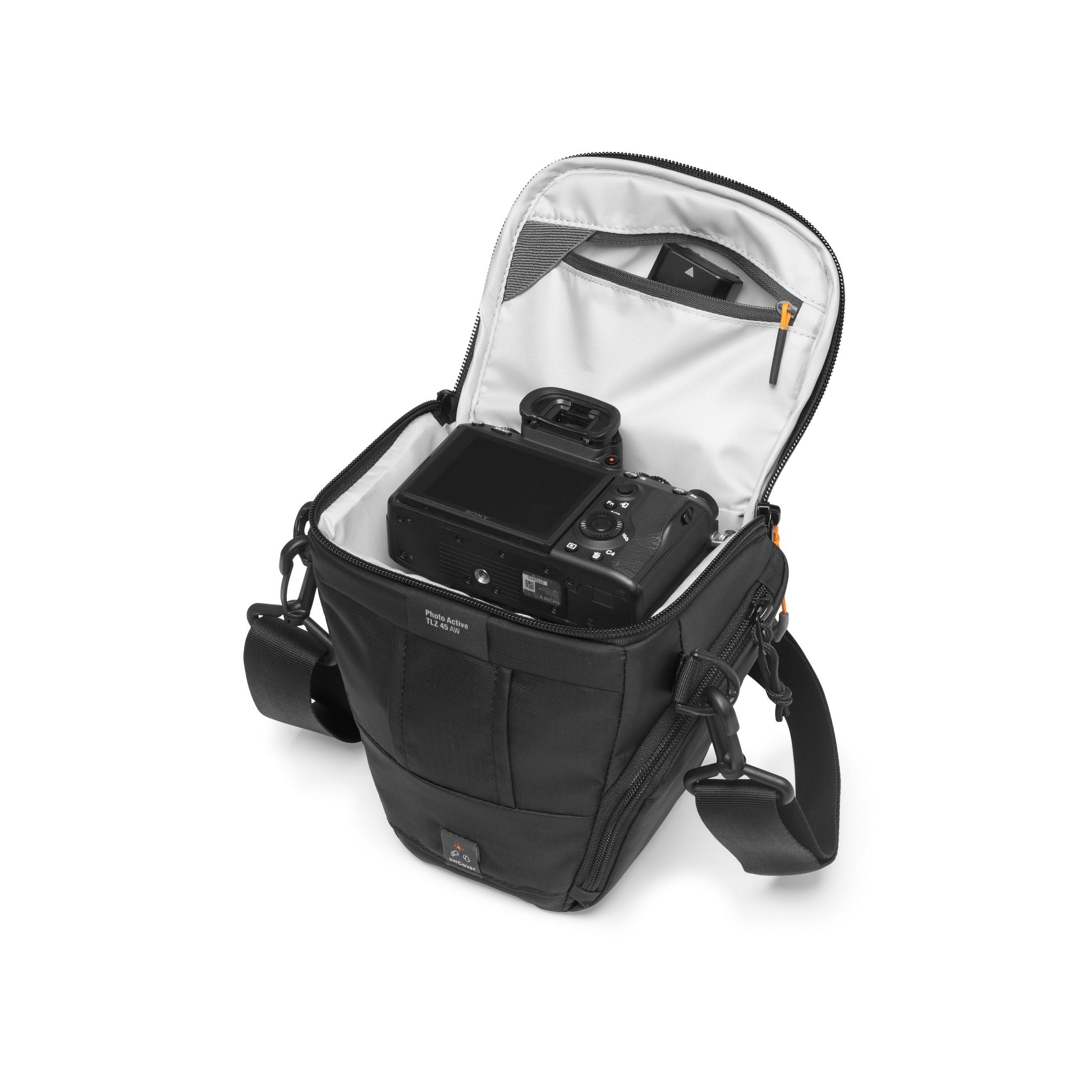 Schwarze Kameratasche mit einer Kamera darin. Die Tasche ist offen und zeigt die Kamera. Weißer Hintergrund.