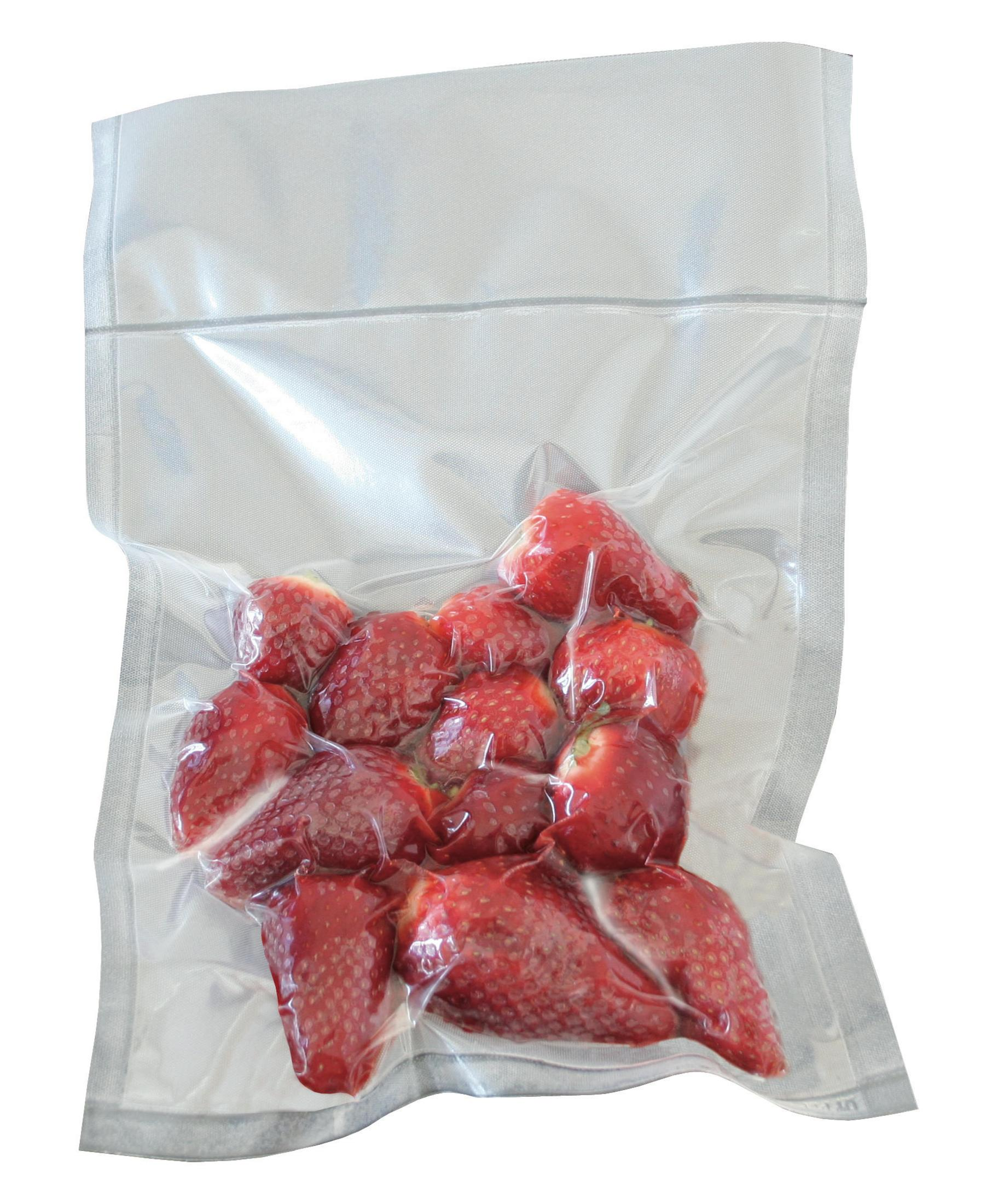 A vacuum-sealed bag of strawberries, red and fresh, against a white background.