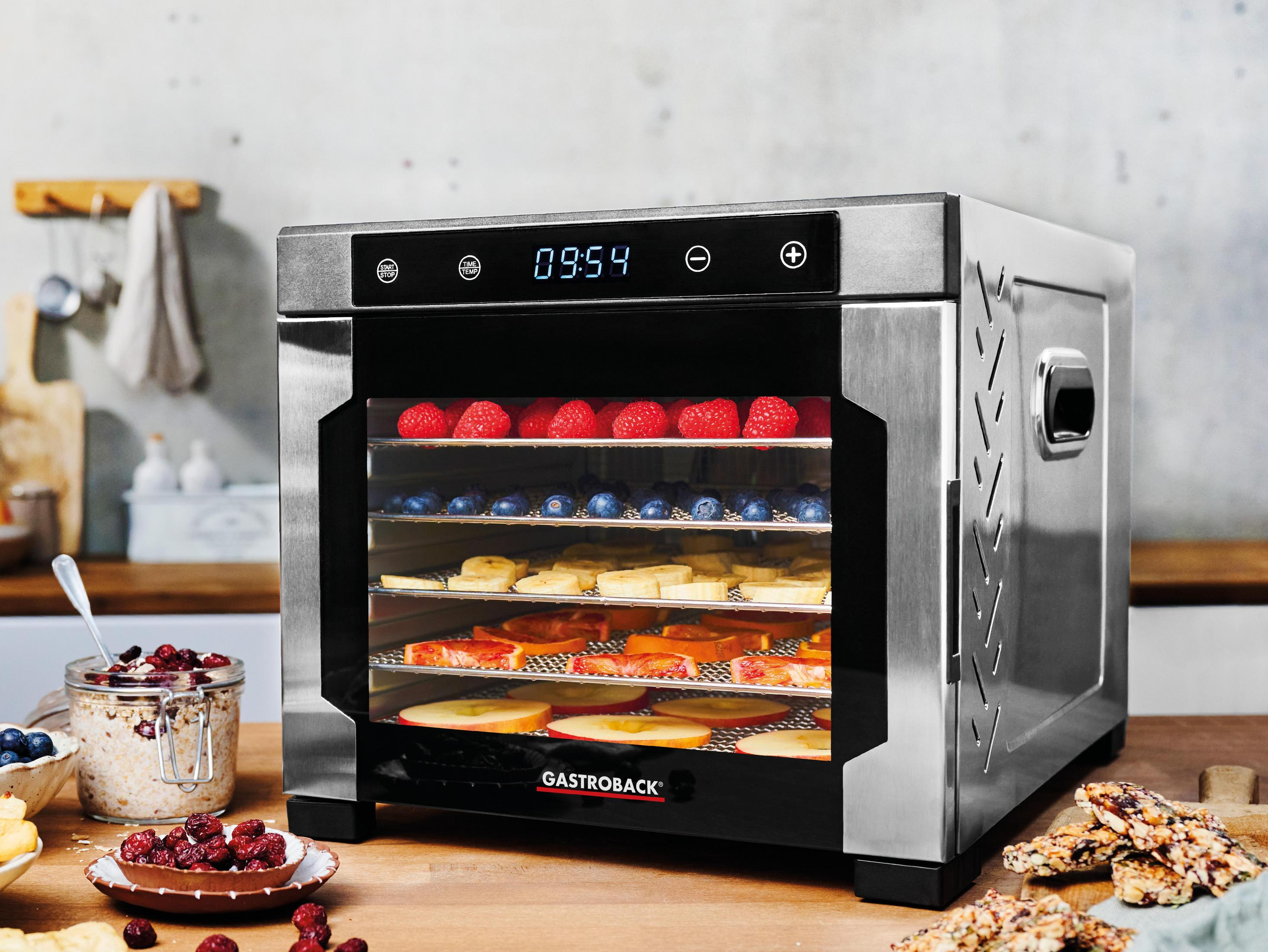 Essiccatore per alimenti, acciaio inossidabile, con frutta e un display timer.