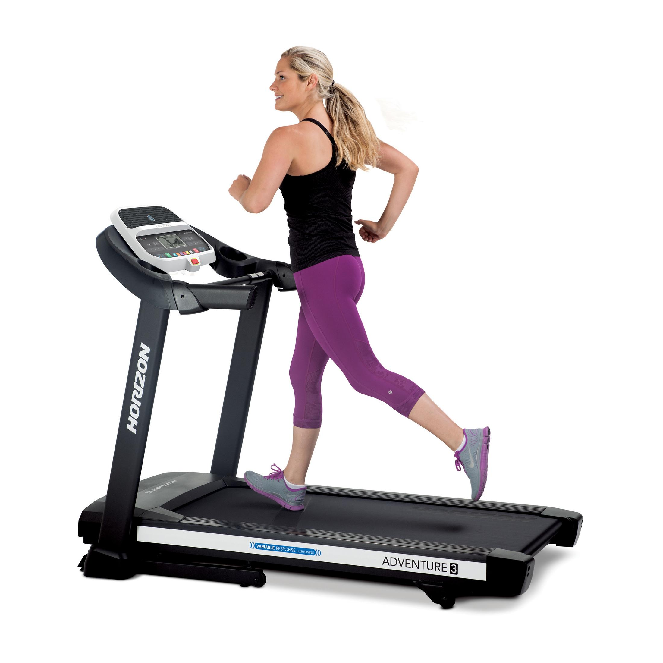A woman running on a treadmill. She is wearing athletic clothes and shoes.