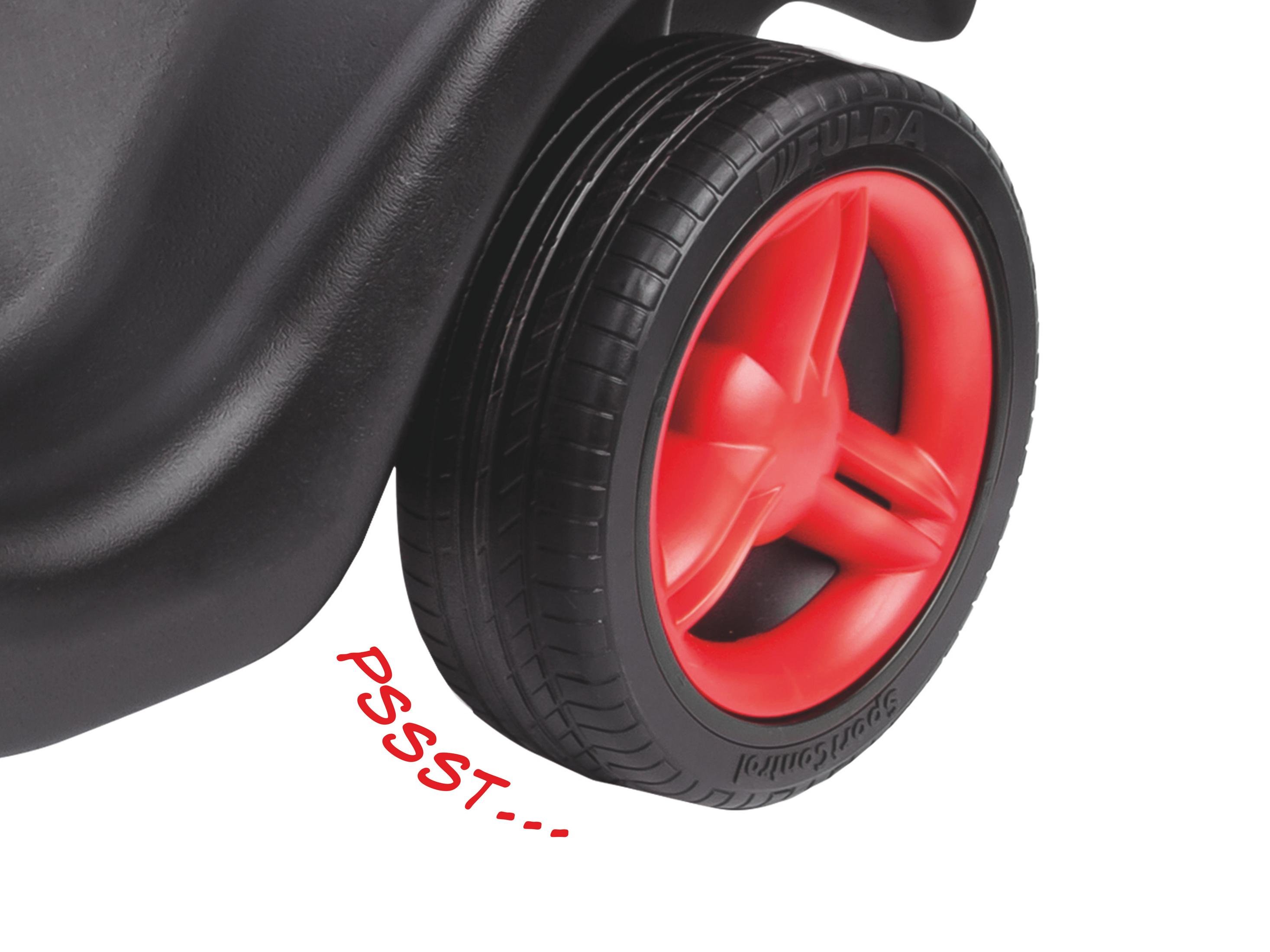 Nahaufnahme eines schwarzen Rades mit roter Mitte, das Wort 'PSSST' ist geschrieben.