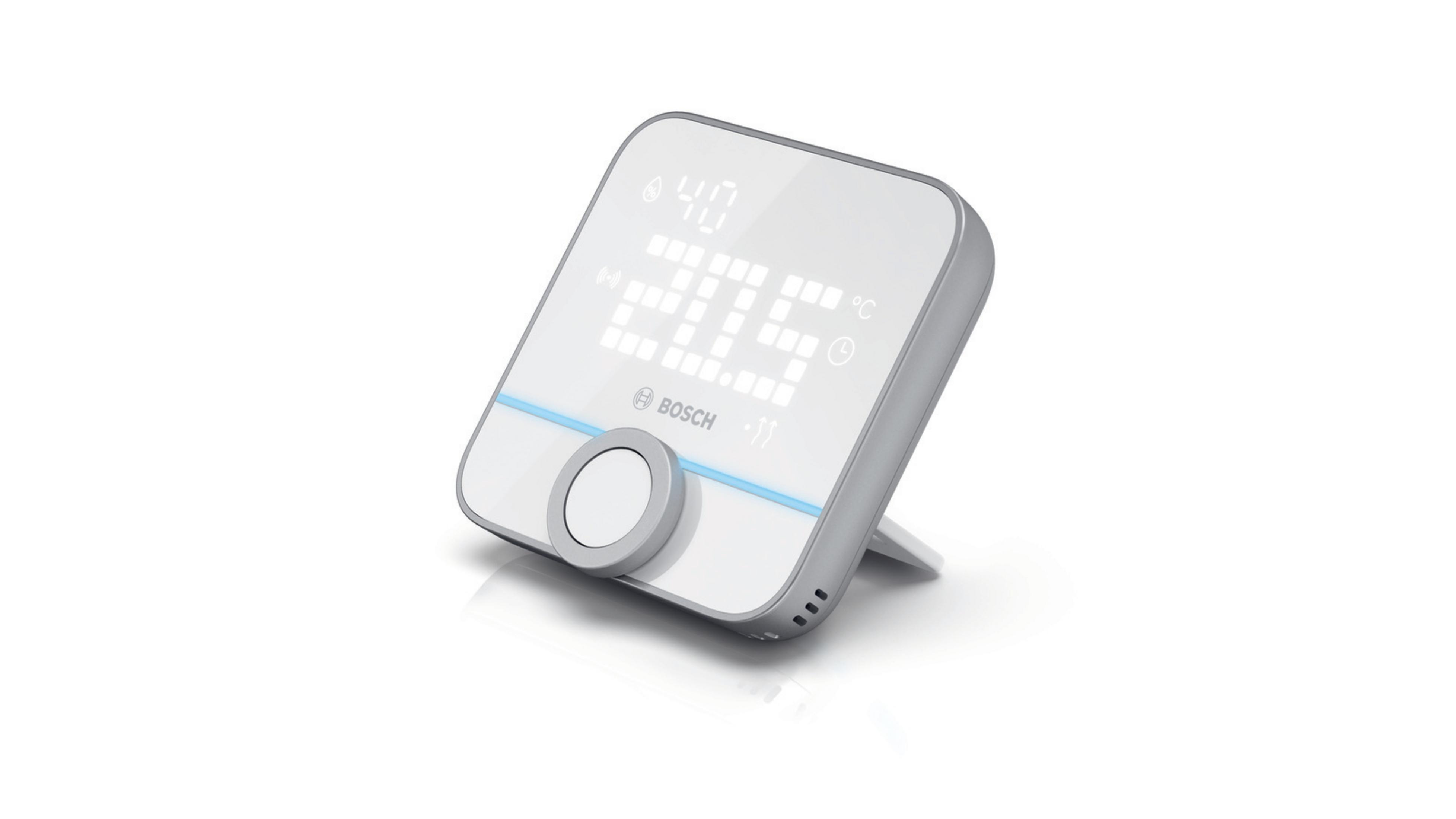 Weißes und graues Smart-Home-Gerät mit Display, weißer Hintergrund.
