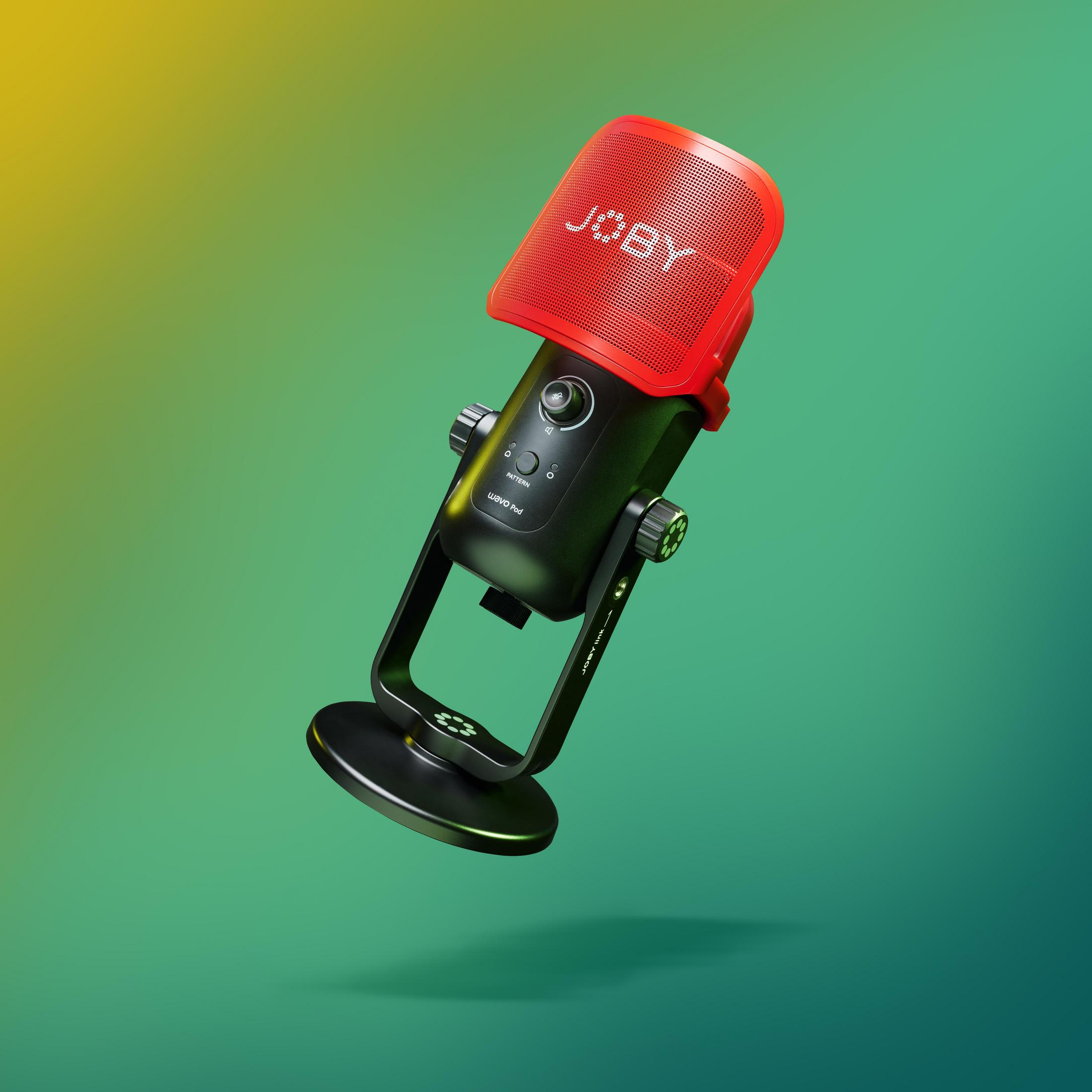 Un micrófono negro con rejilla roja, sobre un fondo degradado verde y amarillo.