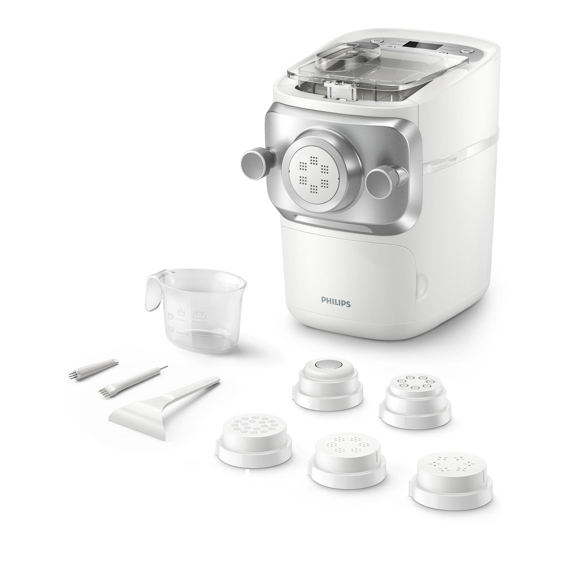 Biała maszynka do makaronu Philips z akcesoriami. Zawiera miarkę, krążki do formowania i narzędzia do czyszczenia.