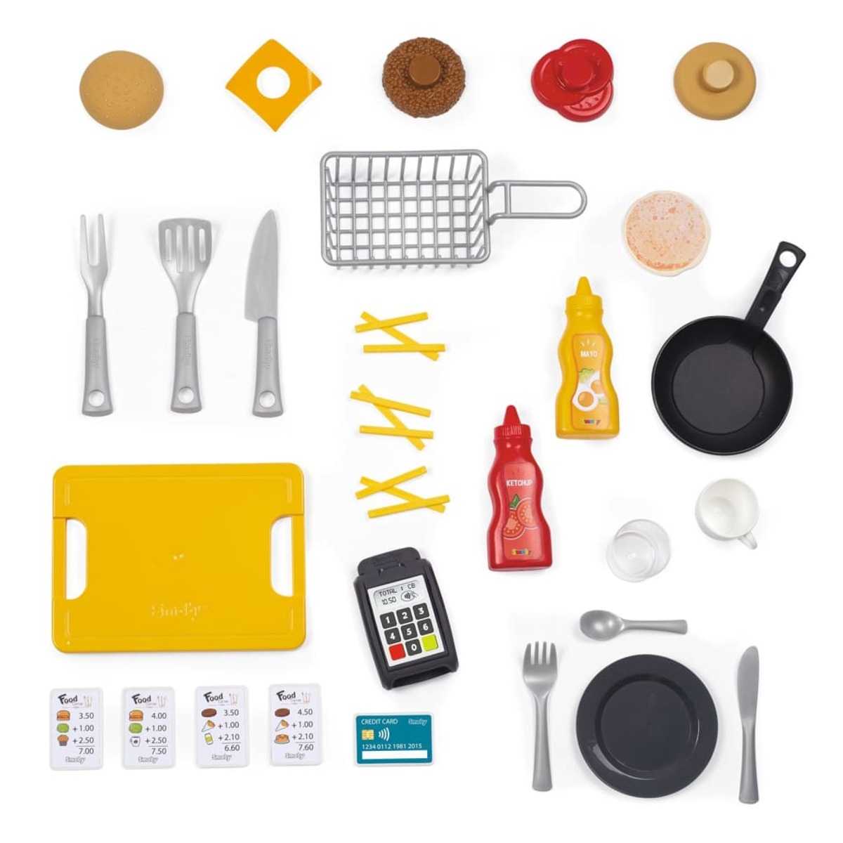 Widok z góry na zabawki spożywcze, w tym deskę do krojenia, talerze i różne produkty spożywcze.