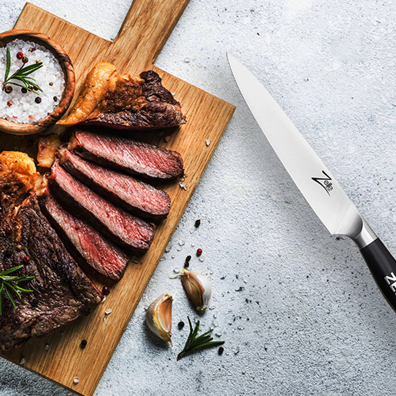 Ein Schneidebrett mit aufgeschnittenem Steak und einem Messer mit schwarzem Griff.