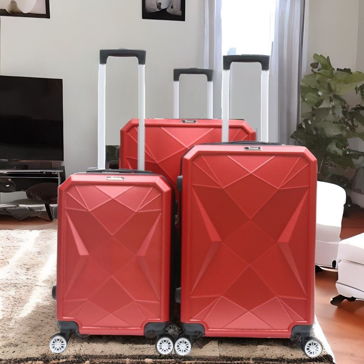 Drei rote Koffer mit Rollen. Sie stehen auf einem Teppich. Im Hintergrund sind ein Sofa und ein Gemälde.