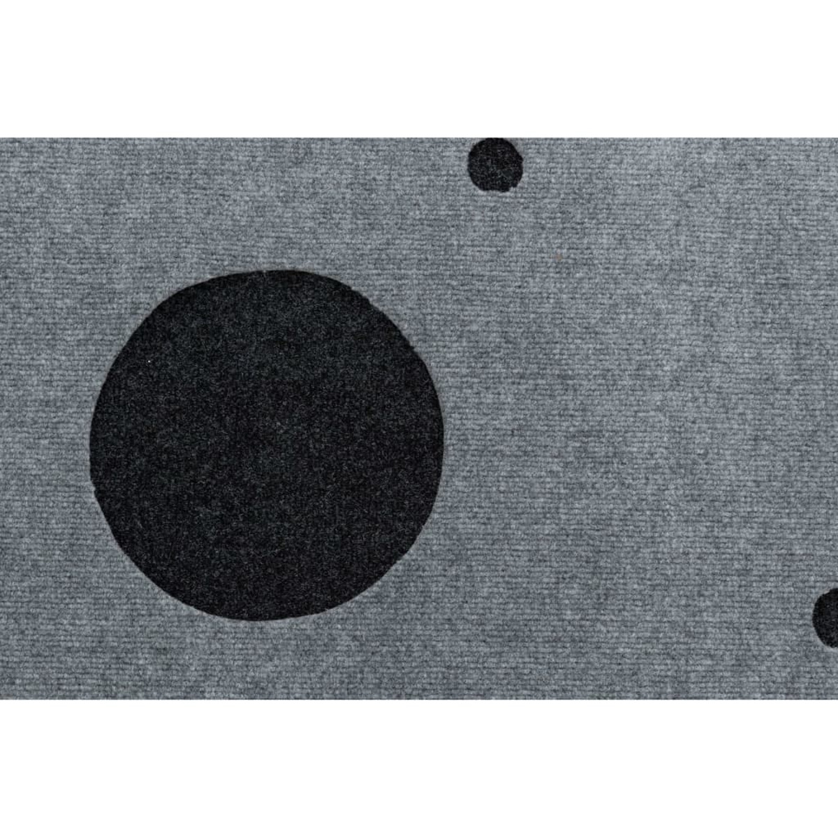 Tappeto grigio con cerchi neri. I cerchi variano di dimensione e sono uniformemente distanziati.
