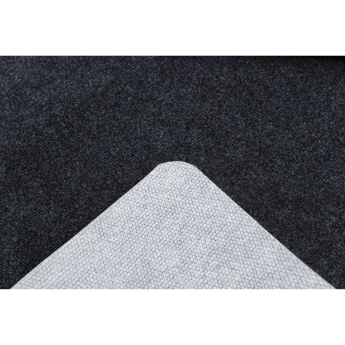Pad triangolare bianco e fantasia su una superficie grigia scura e strutturata.