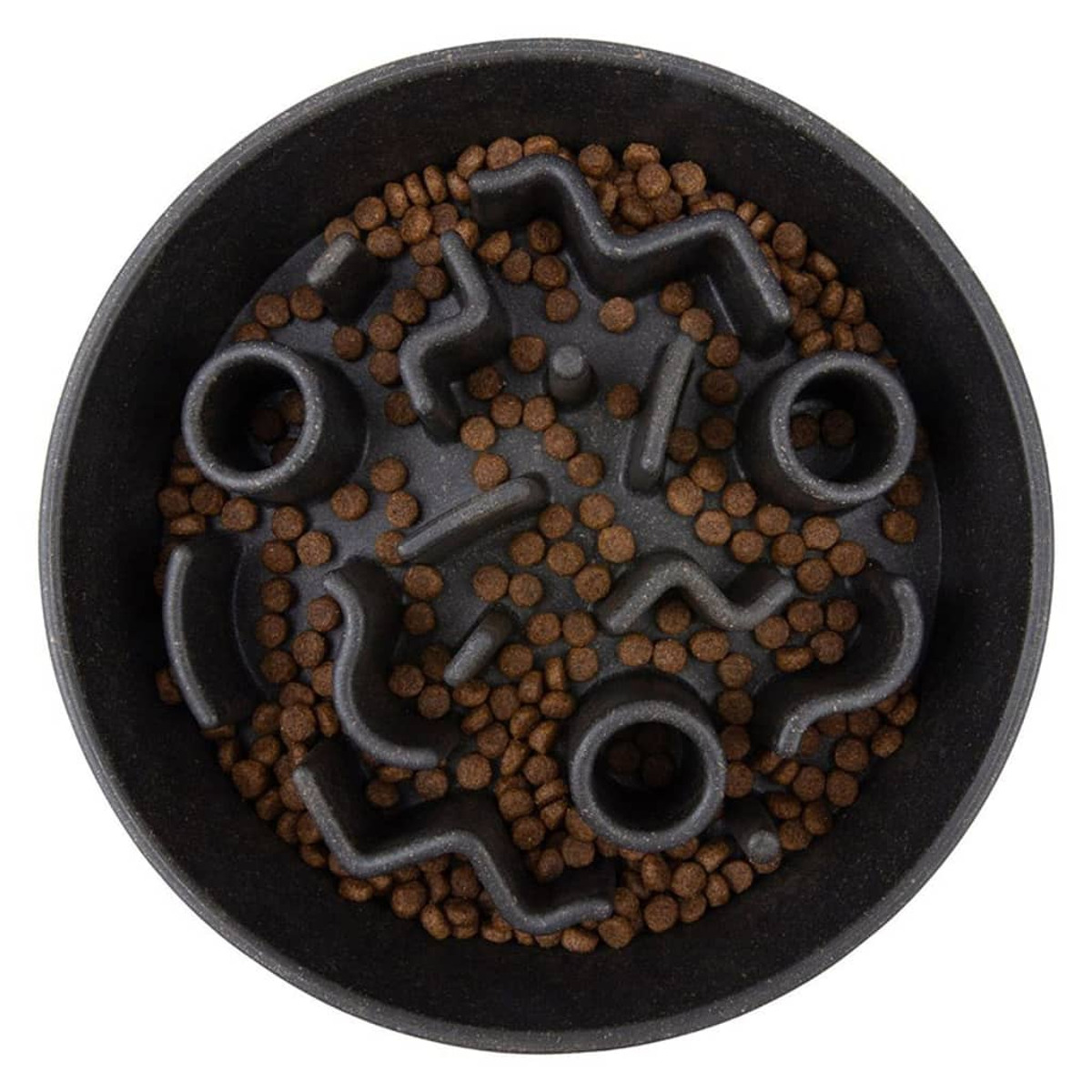 Bol noir pour chien à alimentation lente rempli de croquettes marron. Le bol a un design en forme de labyrinthe.